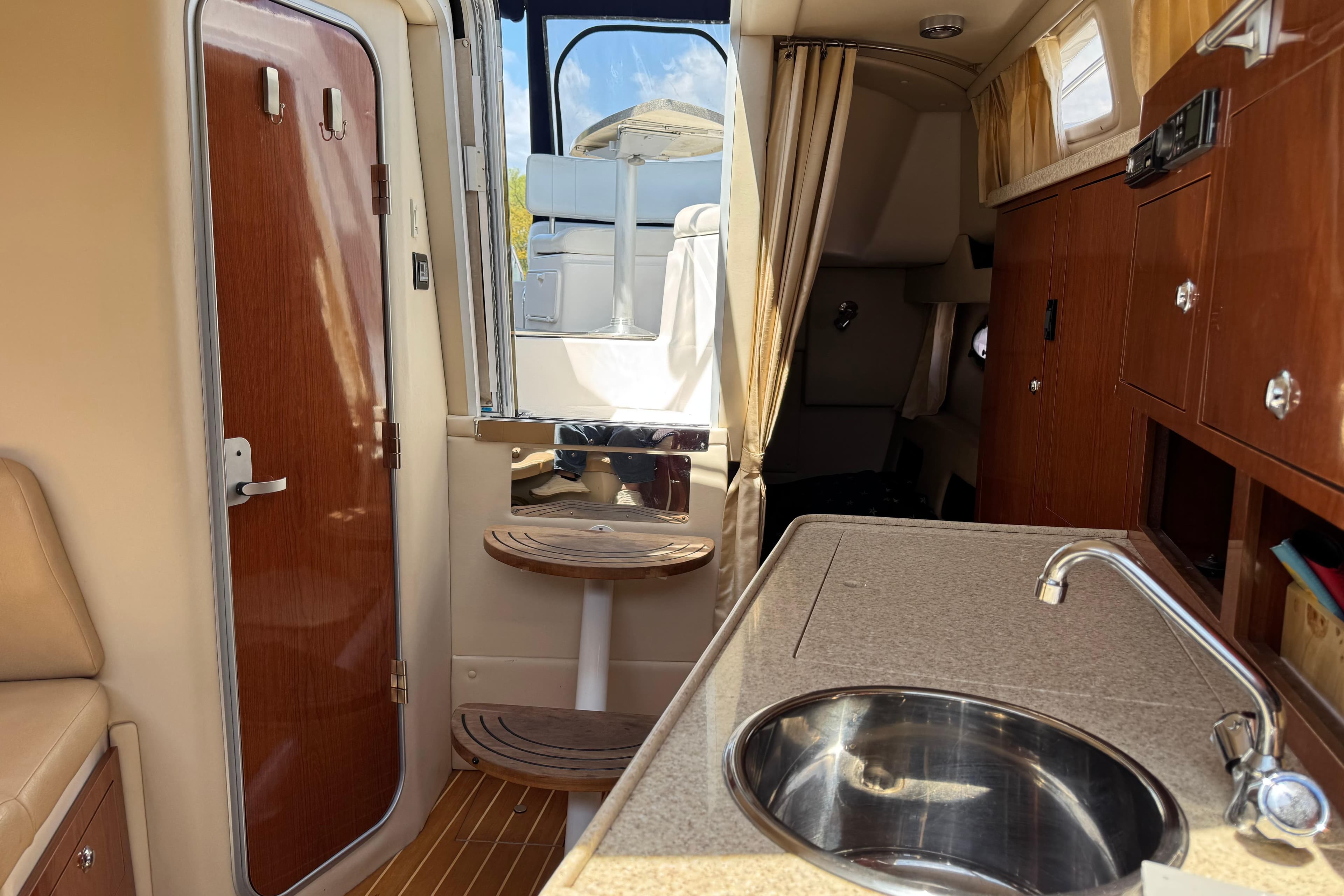 Interior of 2007 Regal 3060 Window Express boat with kitchenette and seating area.