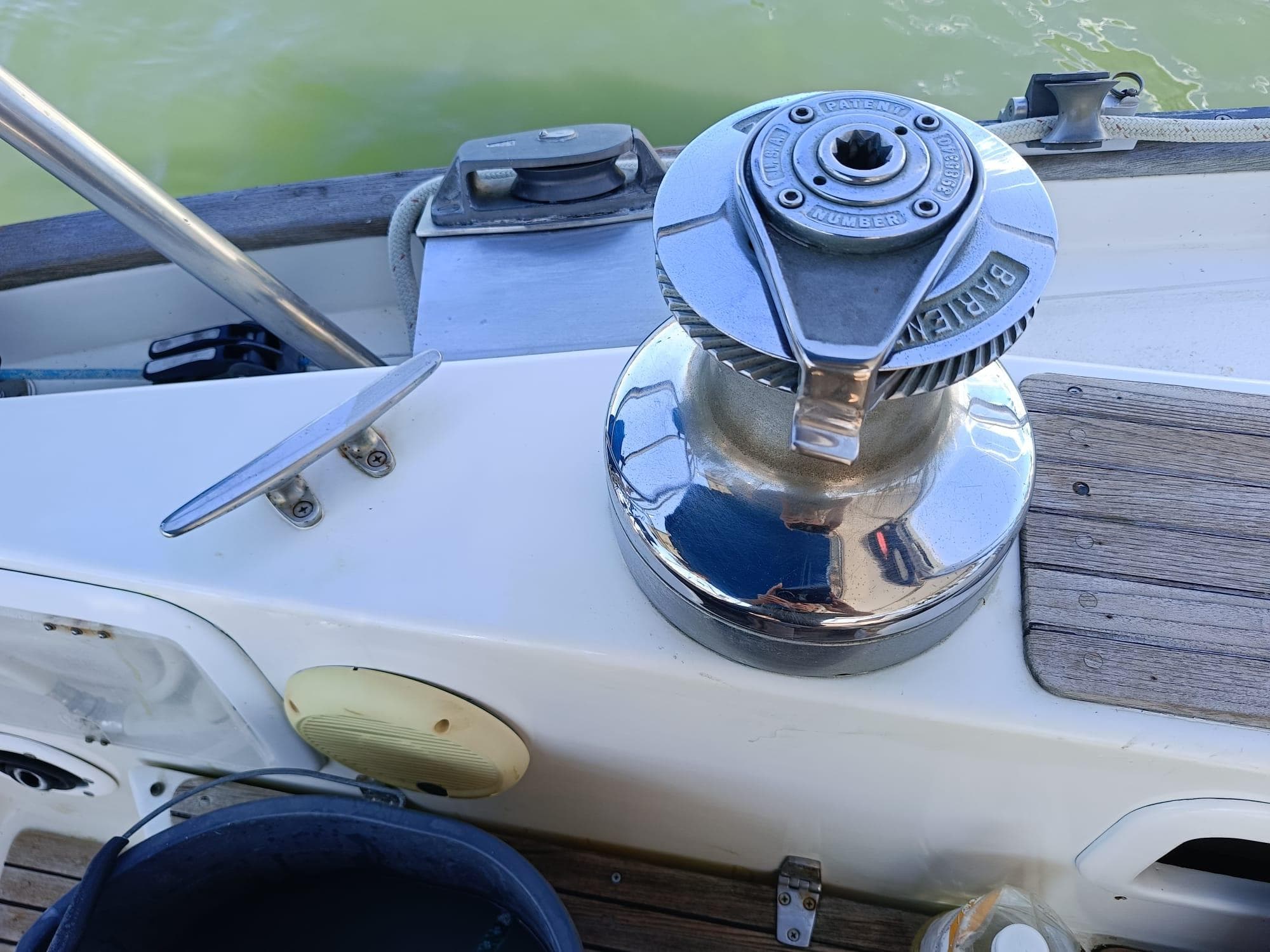 Winch on 1986 Slocum 43 Cutter sailboat deck, near water.