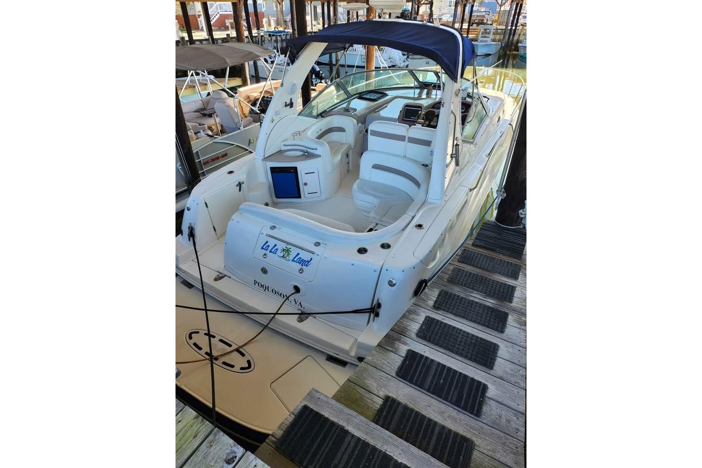 2005 Sea Ray Sundancer 320 docked, featuring spacious seating and sleek design.