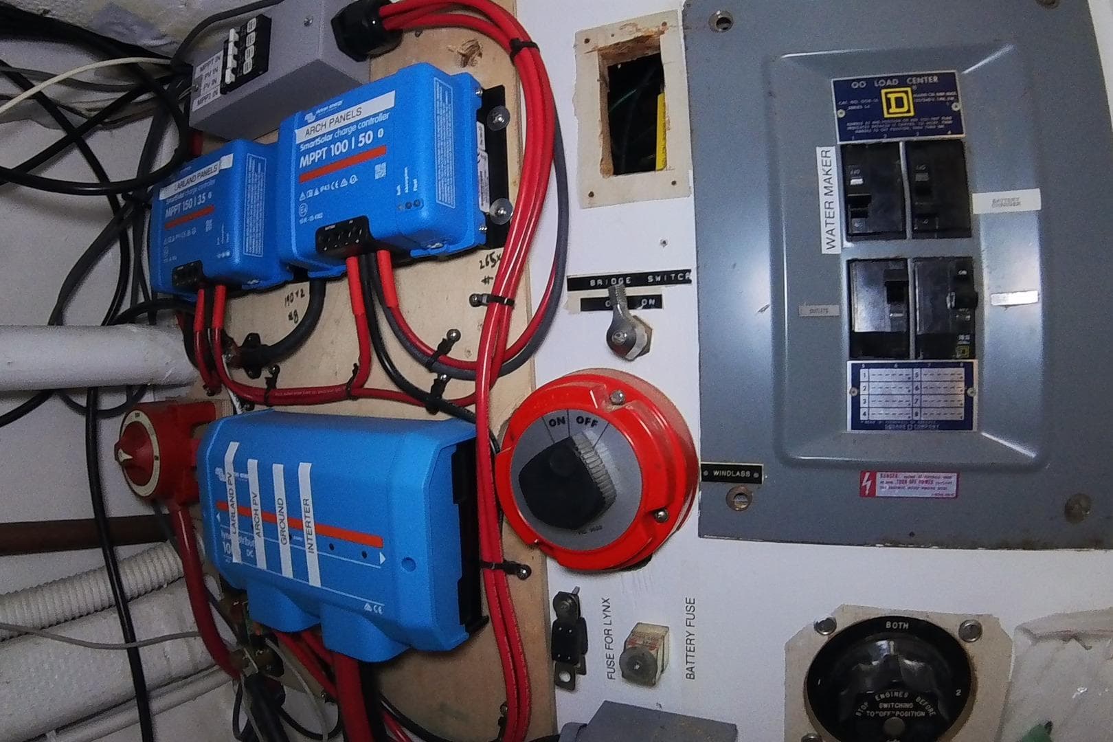 Electrical panel with blue charge controllers and switches on a 1979 Valiant 40 boat.