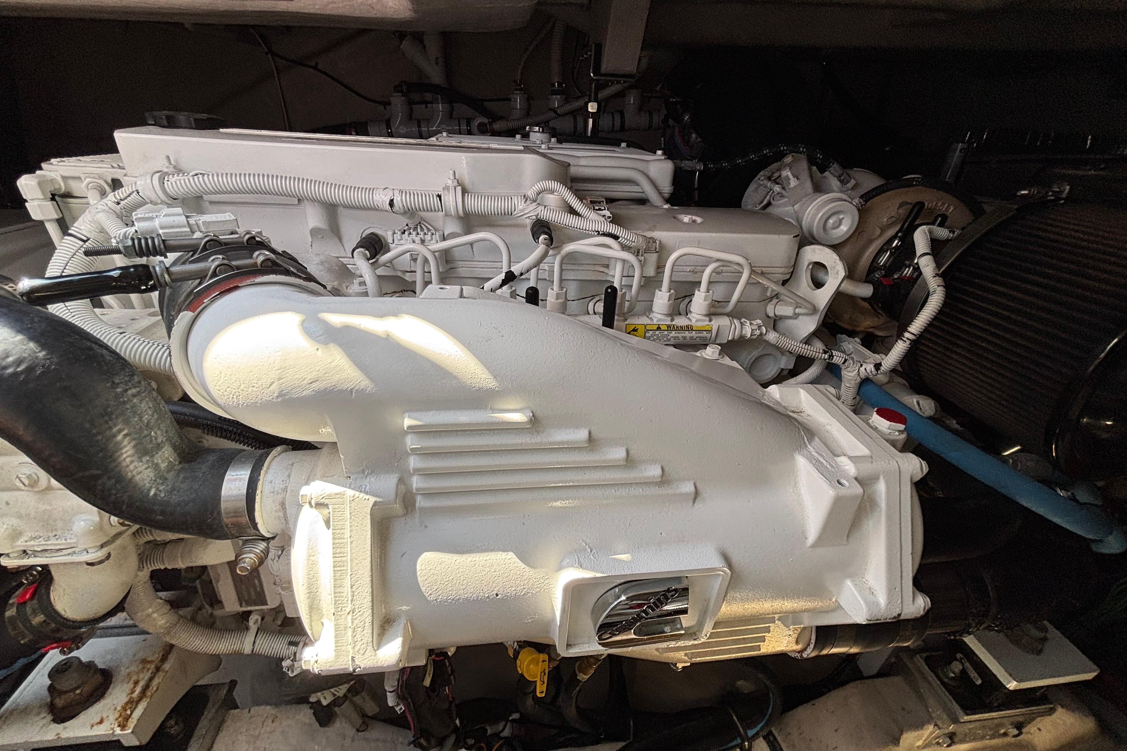 Engine compartment of a 2018 Sea Ray Sundancer 460 yacht, showcasing detailed machinery.