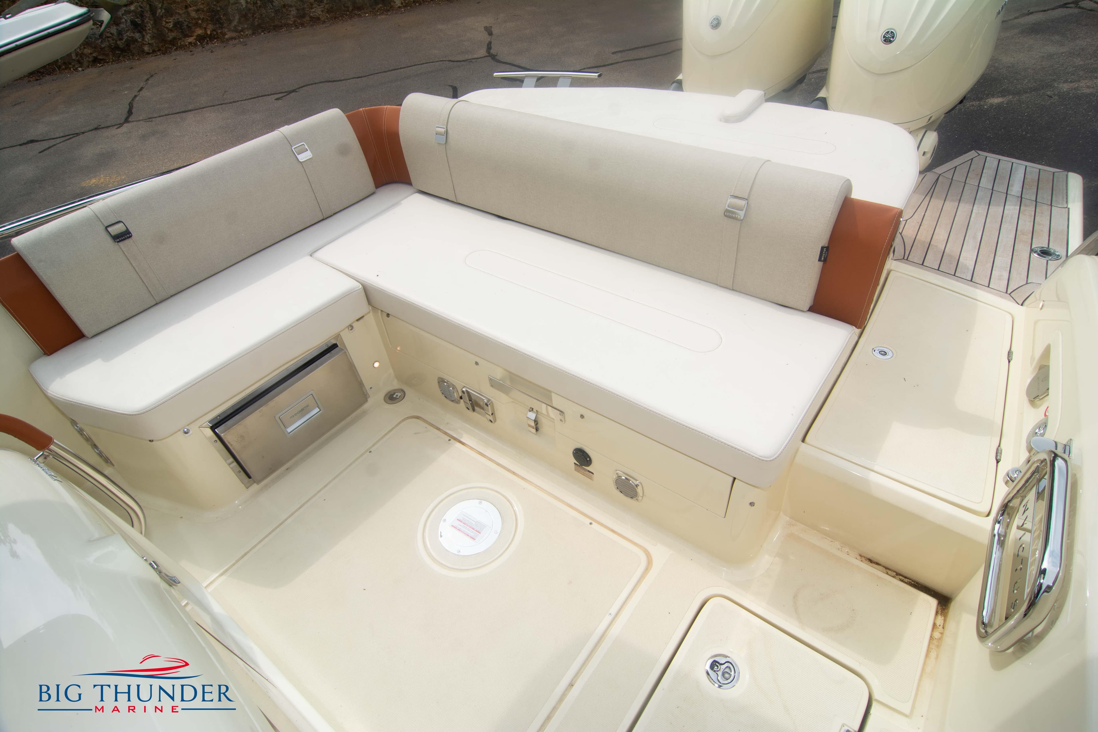 2024 Invictus TT280S boat seating area with storage compartments, showcased by Big Thunder Marine.