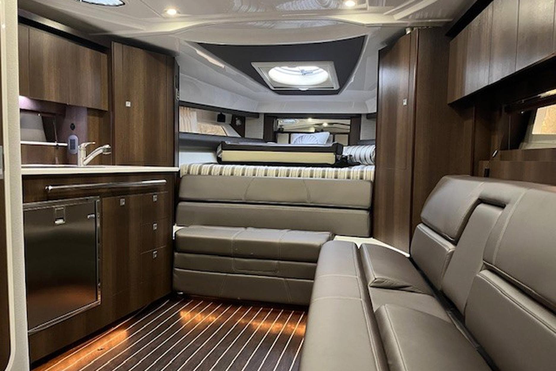 Luxurious interior of 2018 Monterey 335 Sport Yacht with modern furnishings and wood accents.