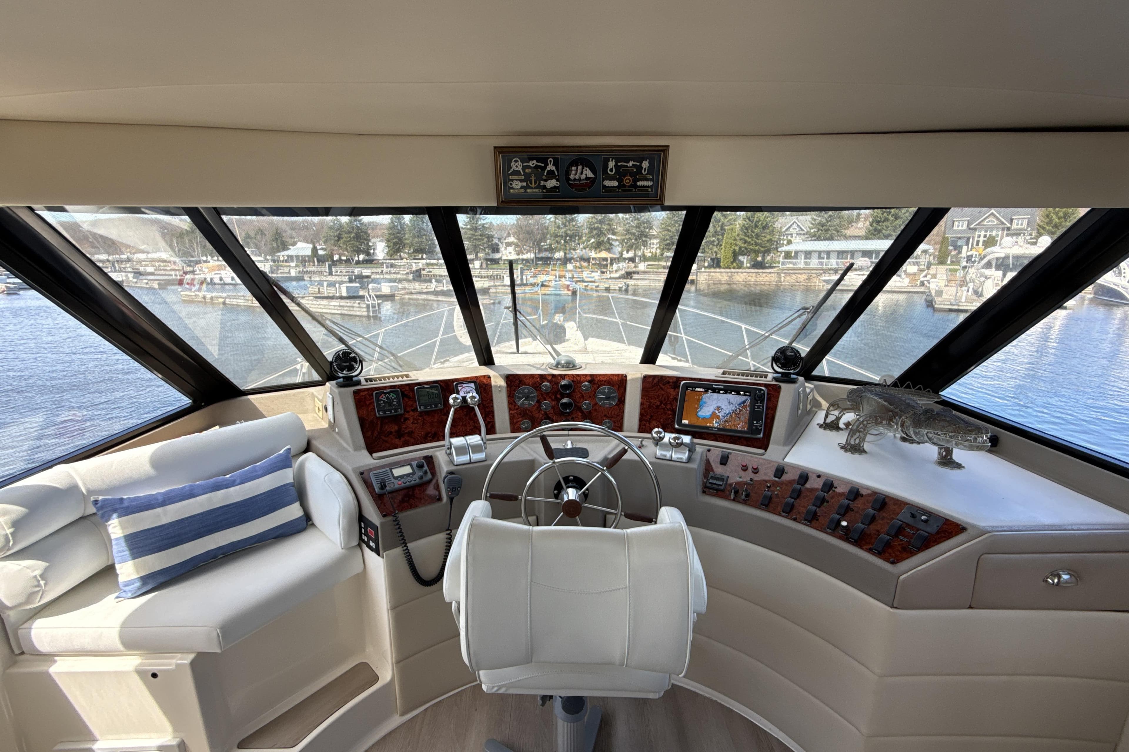 Interior view of 1997 Bayliner 4788 Pilot House Motoryacht helm with panoramic windows.