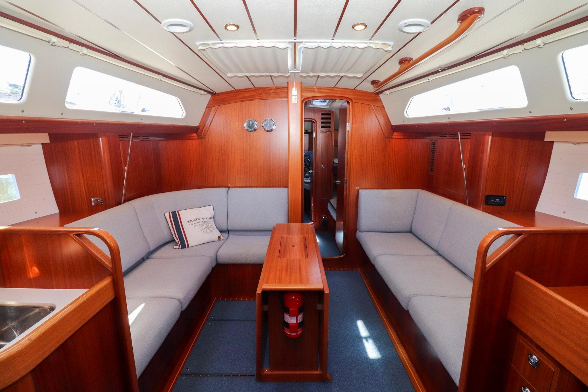 Luxurious 2018 Hallberg Rassy 44 yacht interior with elegant wood finish and comfortable seating.