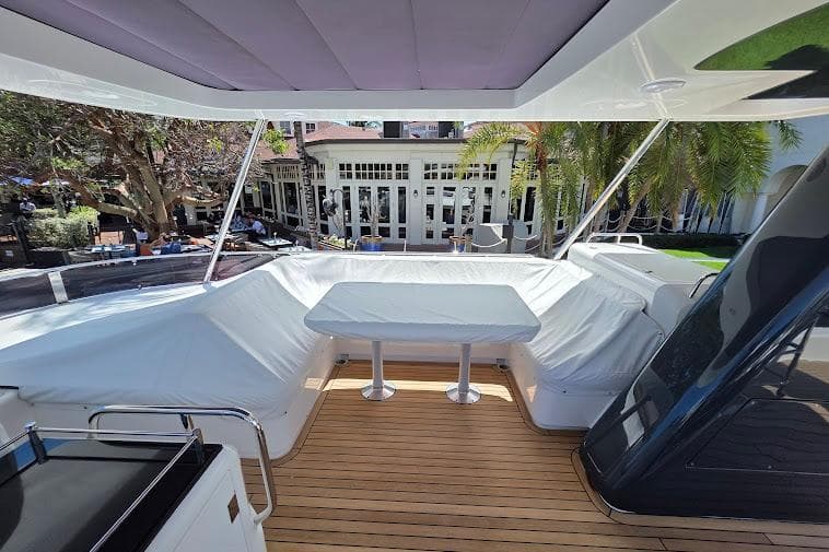 Luxurious 2024 Sirena 58 Flybridge yacht with spacious outdoor seating and dining area.