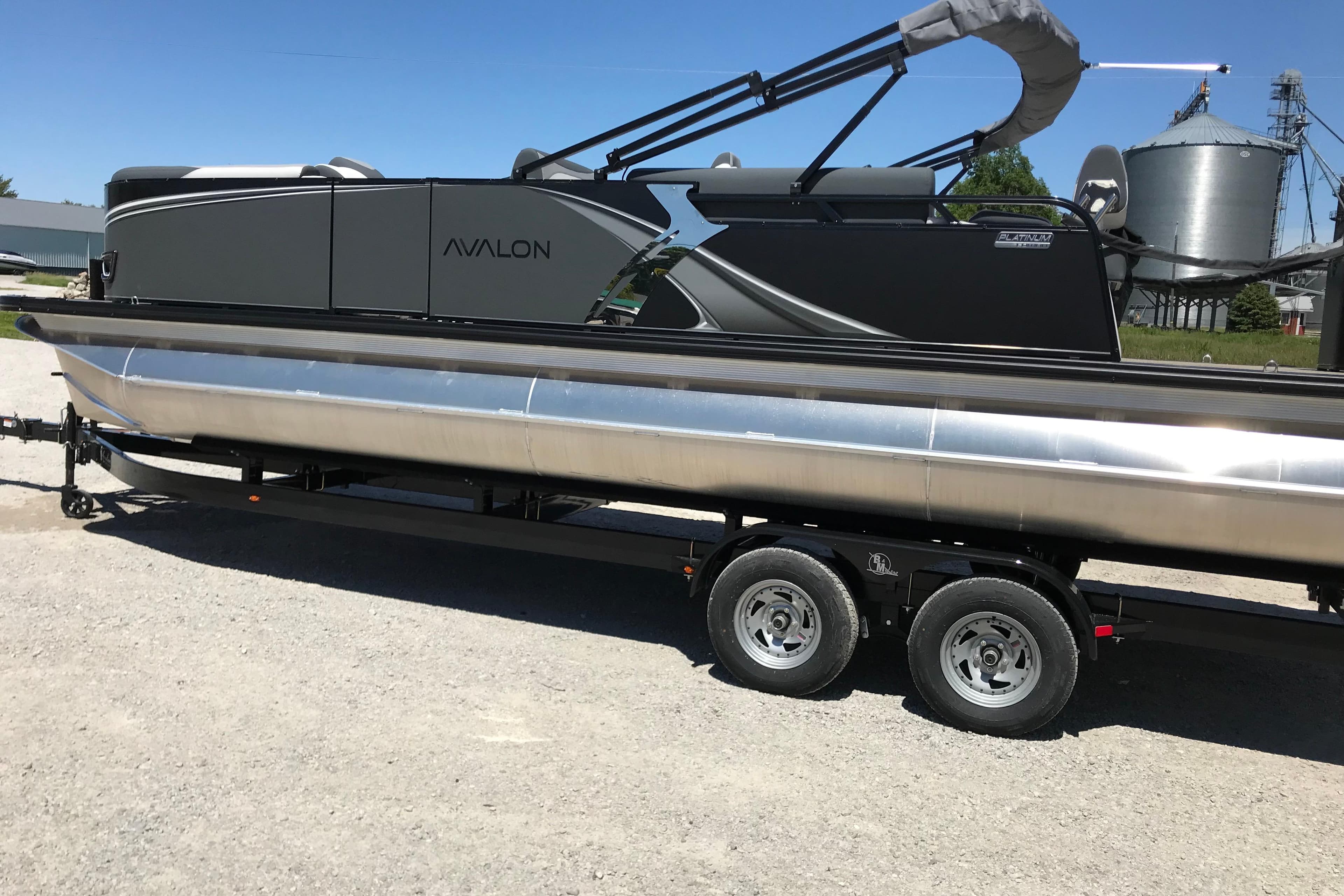 2026 Avalon LSZ Quad Lounge Shift-25' pontoon boat with patio pad on trailer.