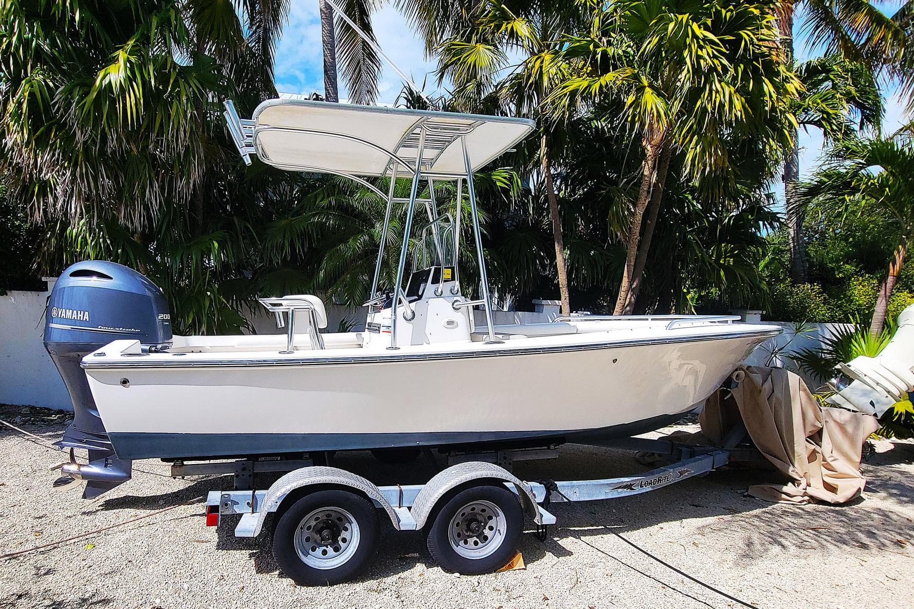 2008 SeaCraft SC 20 Classic boat on trailer, surrounded by palm trees.