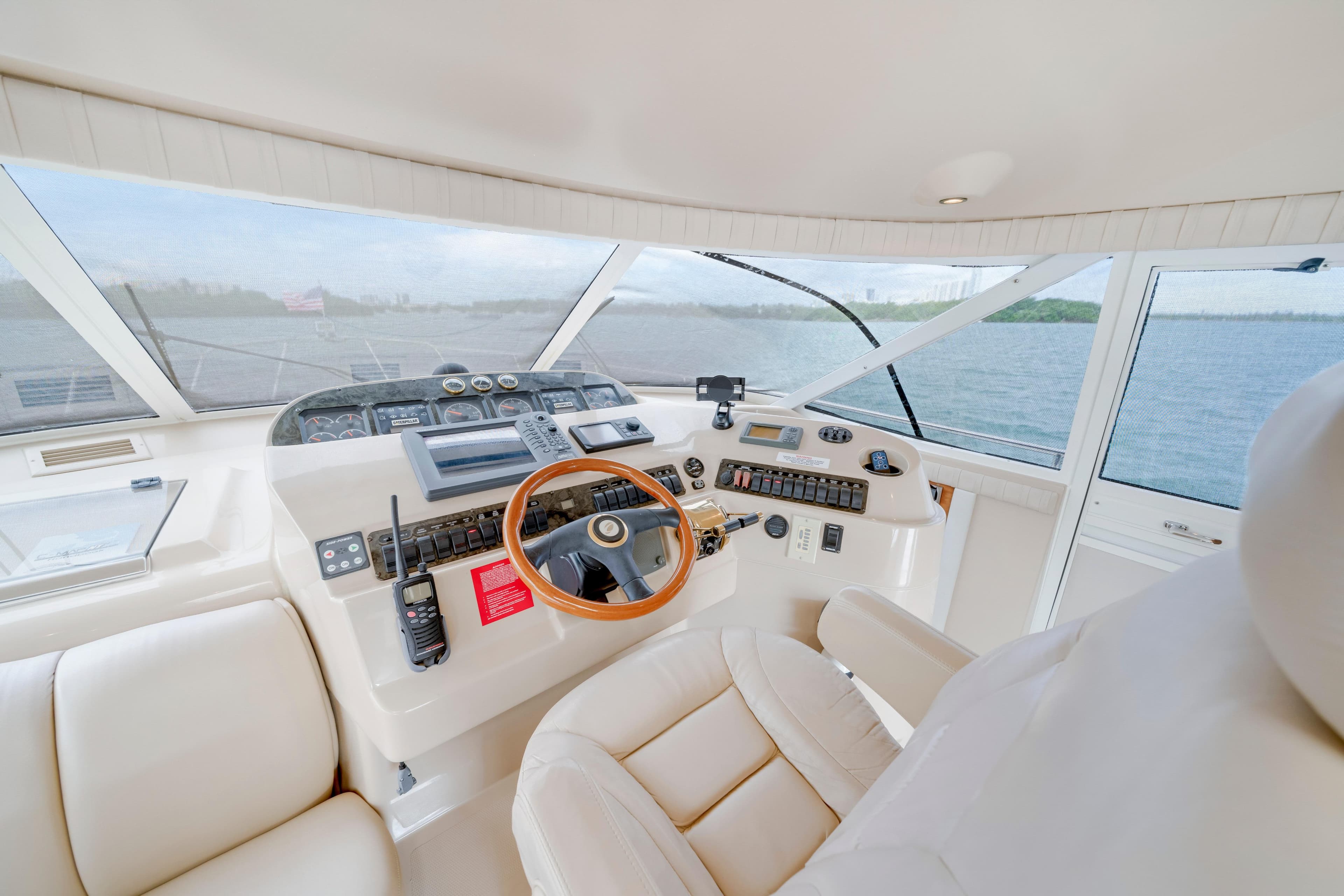 2001 Cruisers Yachts 5000 Sedan Sport helm with luxurious leather seating and panoramic views.
