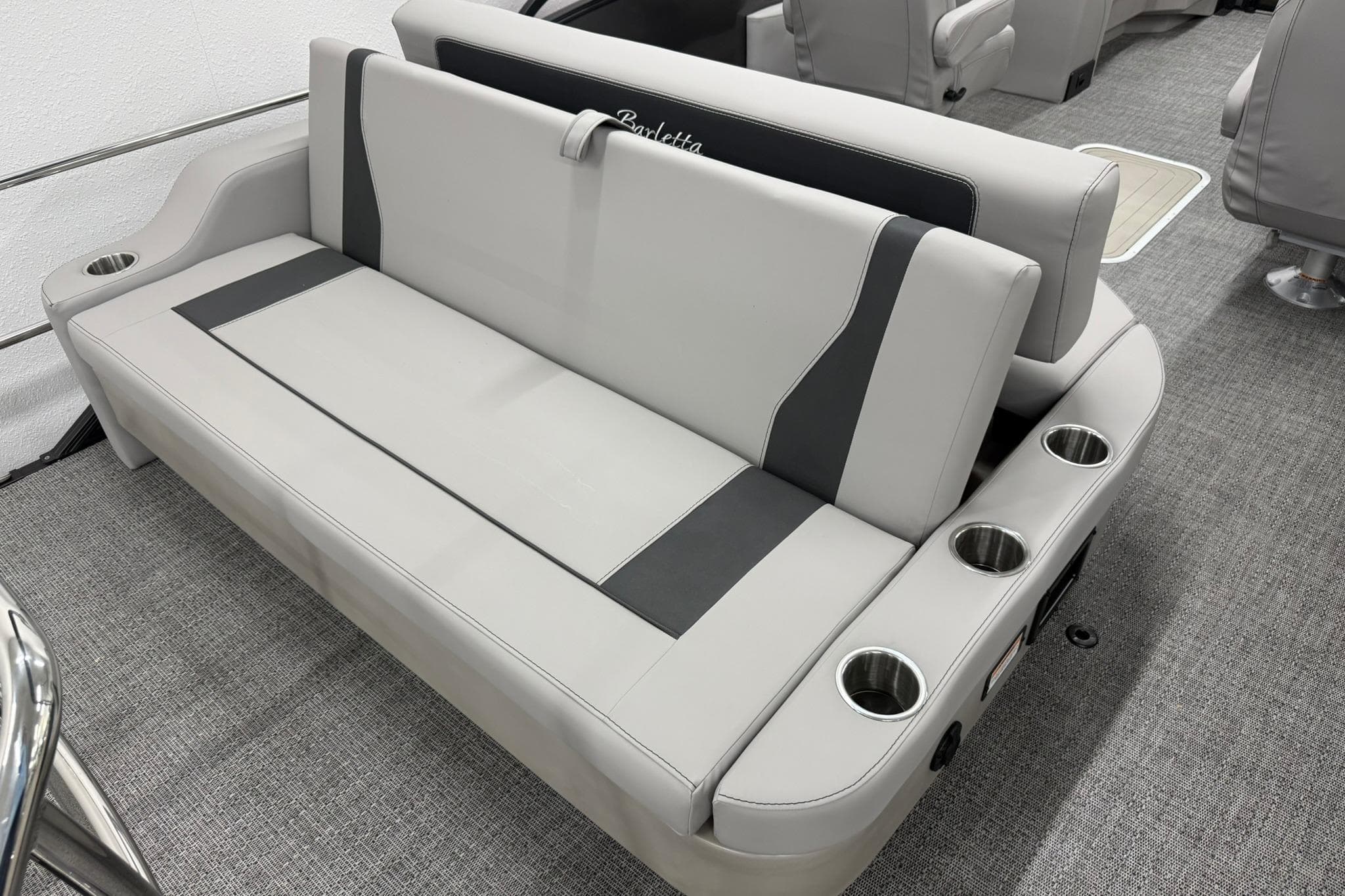 Luxurious seating on 2026 Barletta ARIA 22UC boat with integrated cup holders.