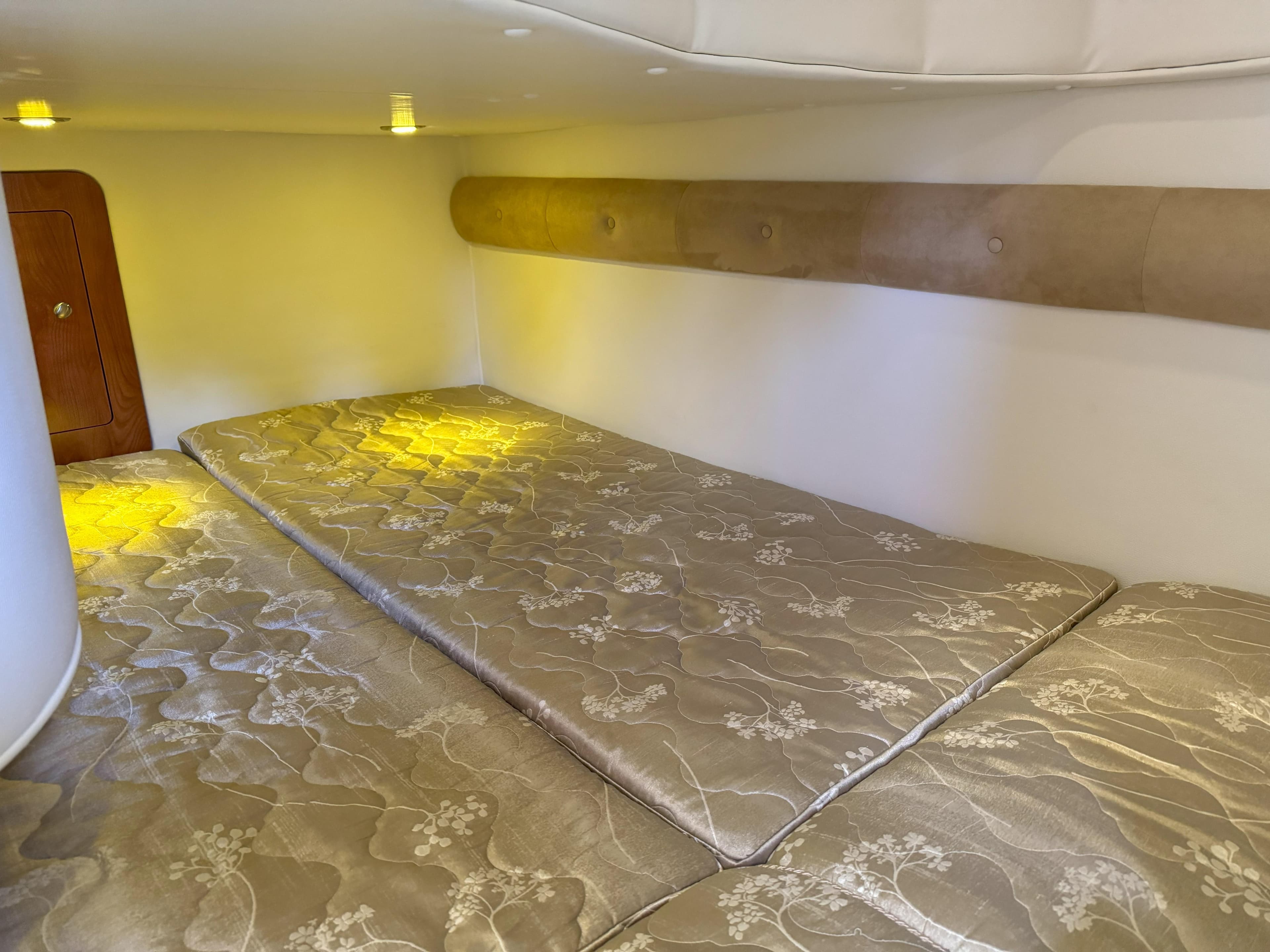 Interior of 2010 Rinker 310 Express Cruiser with sleeping area.