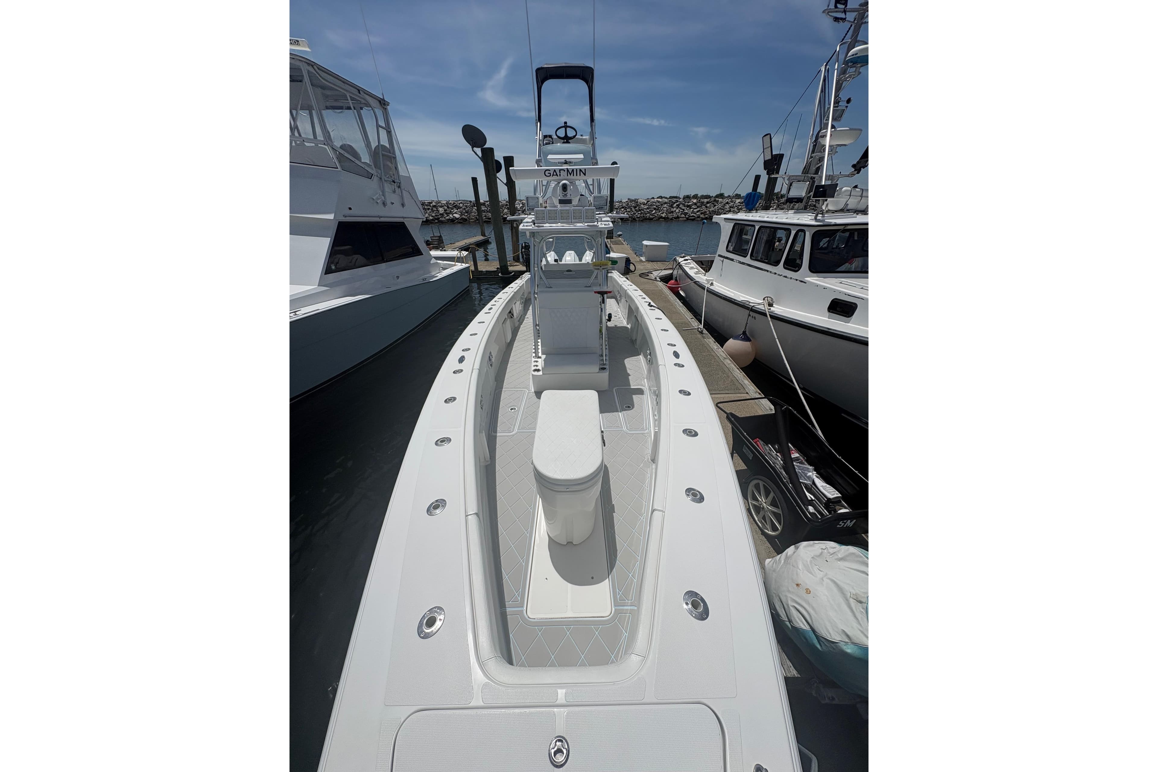 2019 Concept 392 ProFish boat docked, showcasing sleek design and spacious deck.