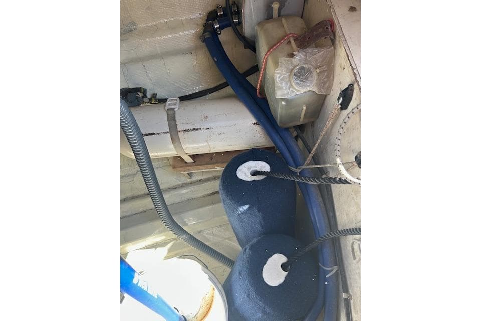 Interior of 1982 Ericson 33 sailboat showing ropes, cables, and equipment.