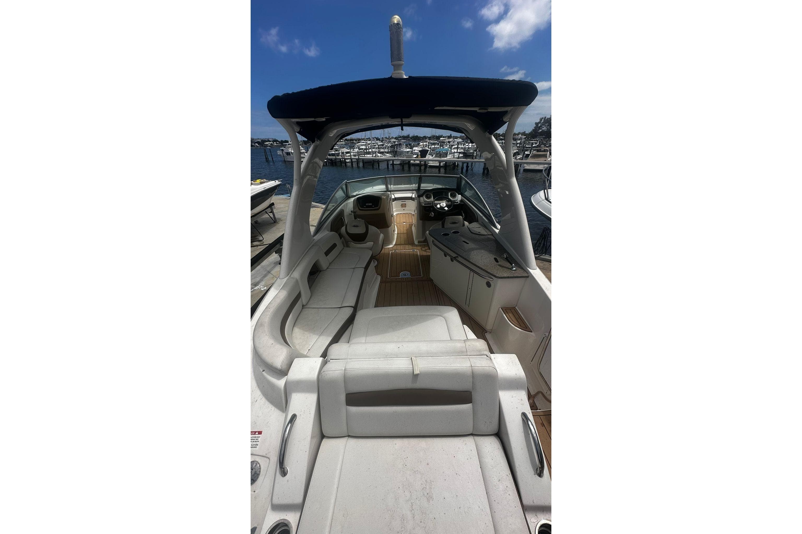 2015 Chaparral 264 Sunesta boat interior with seating and helm, docked at marina.