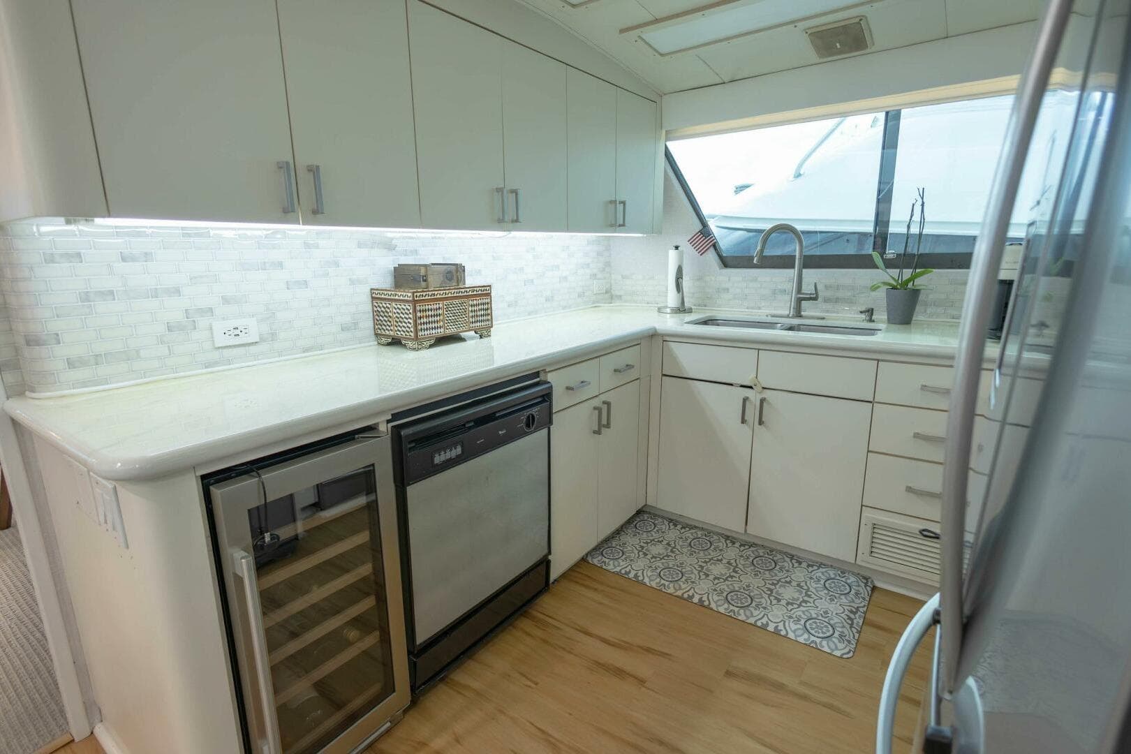 Modern kitchen in 1989 Hatteras Custom Cockpit yacht with sleek cabinetry and appliances.