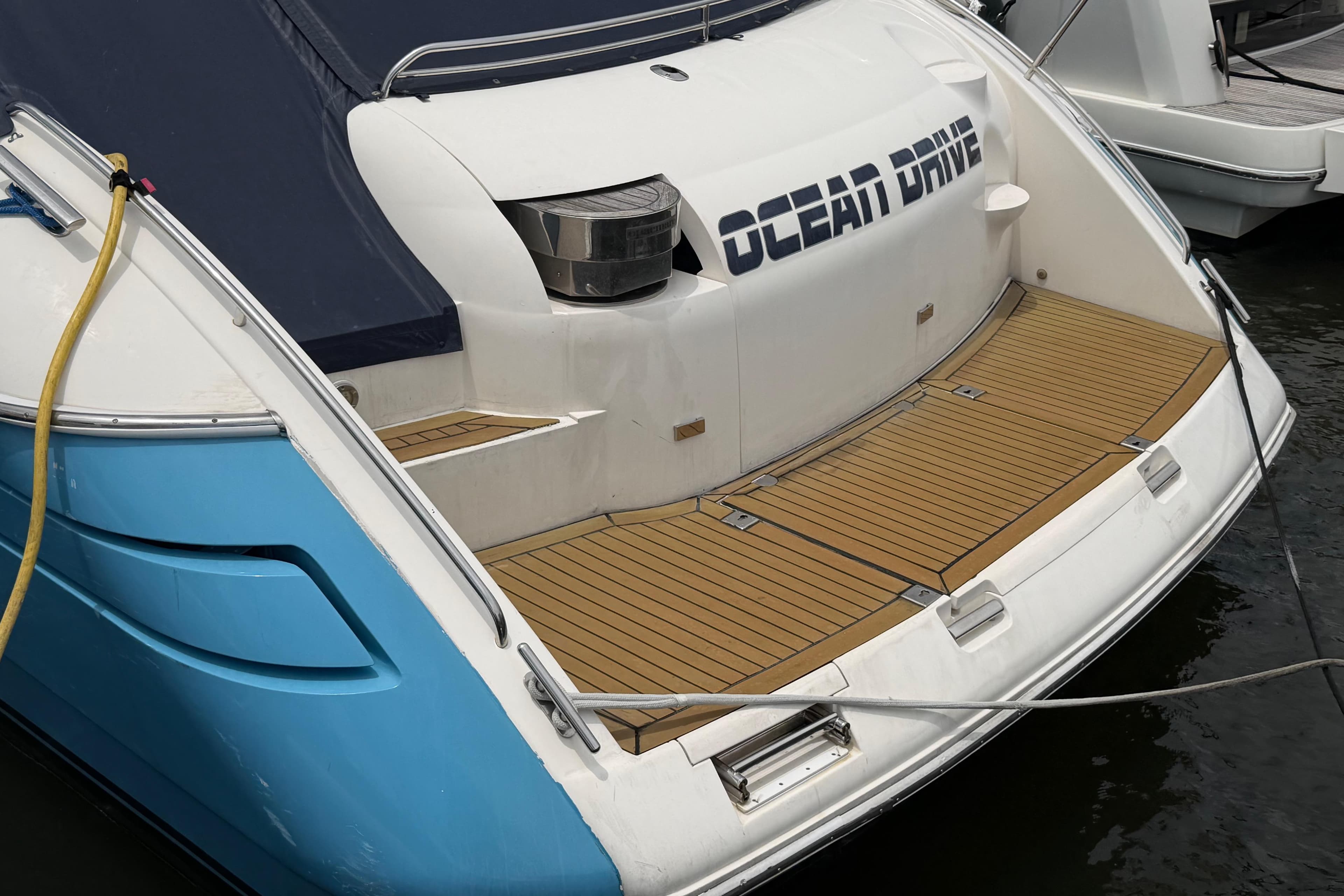 2003 Viking Princess V50 yacht with "Ocean Drive" text on the stern, docked at marina.