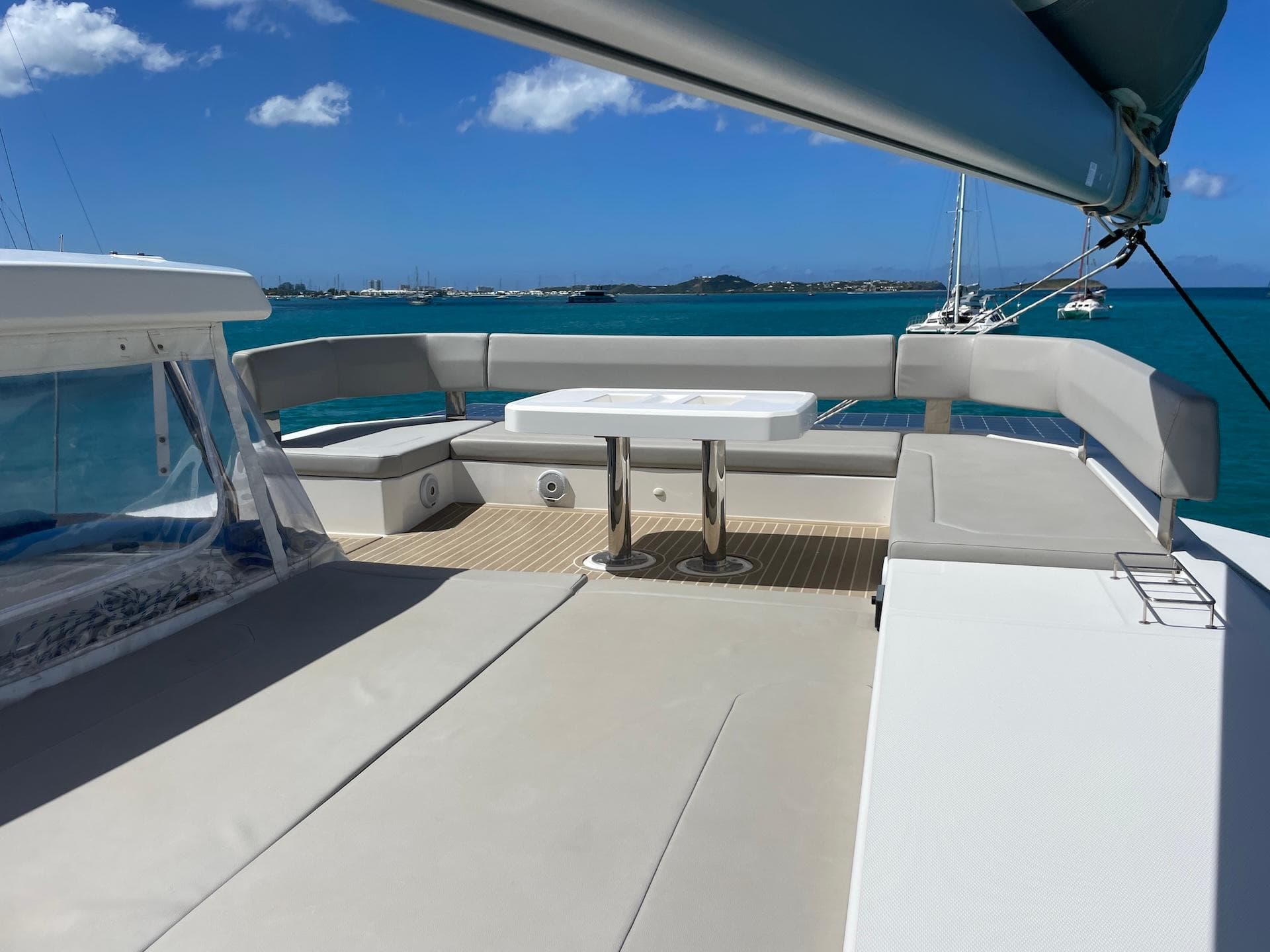 Luxurious Leopard 45 catamaran deck with seating, table, and ocean view, 2021 model.