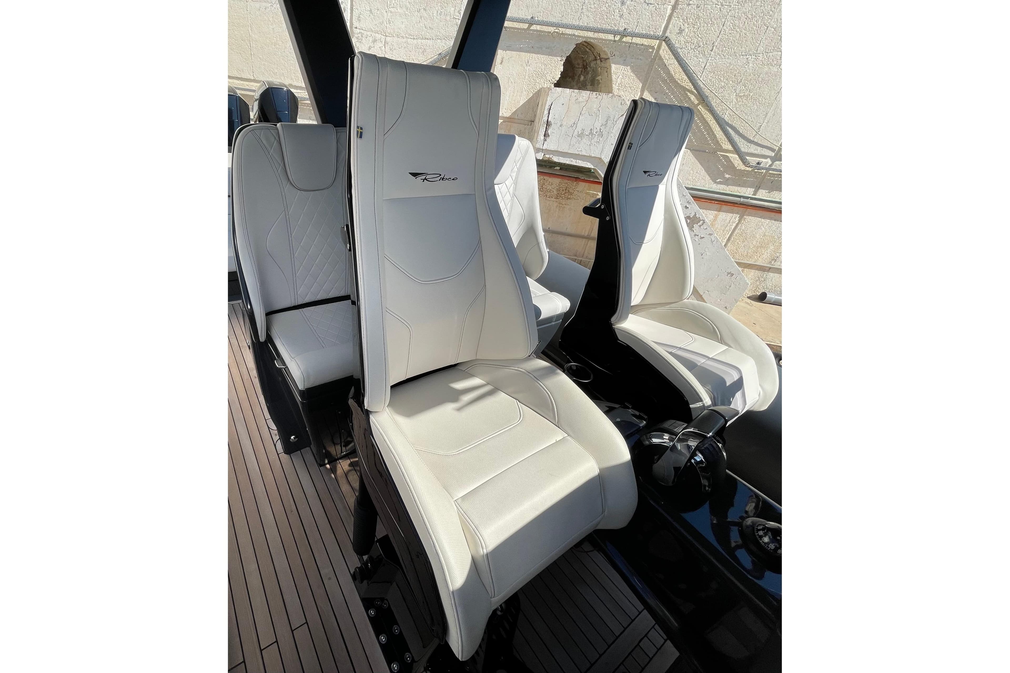 Luxurious white seats on a 2018 Ribco Venom 44 Open boat, showcasing sleek design.