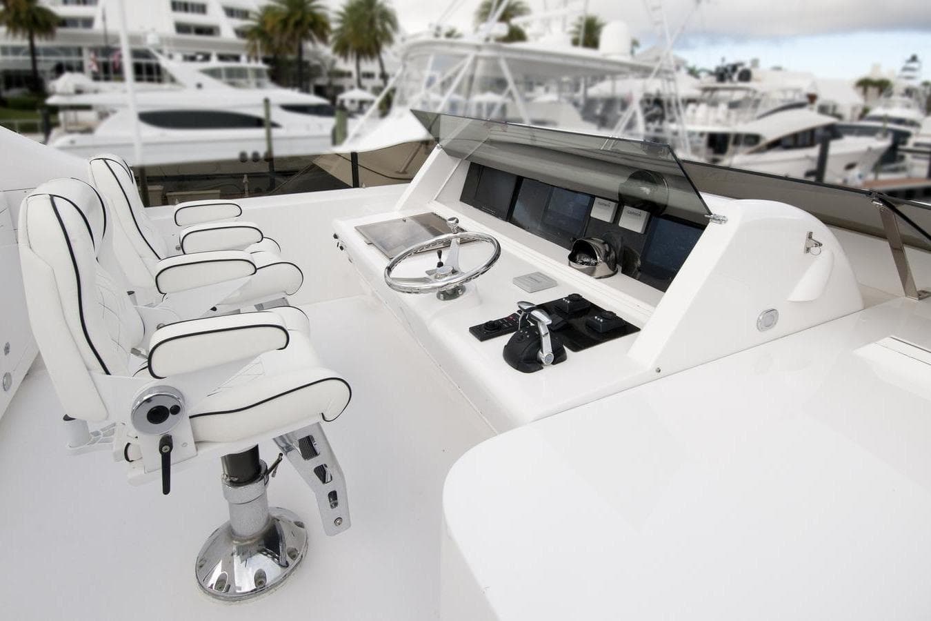 Luxurious 1995 Custom Heisley yacht helm with white leather seats and modern controls.