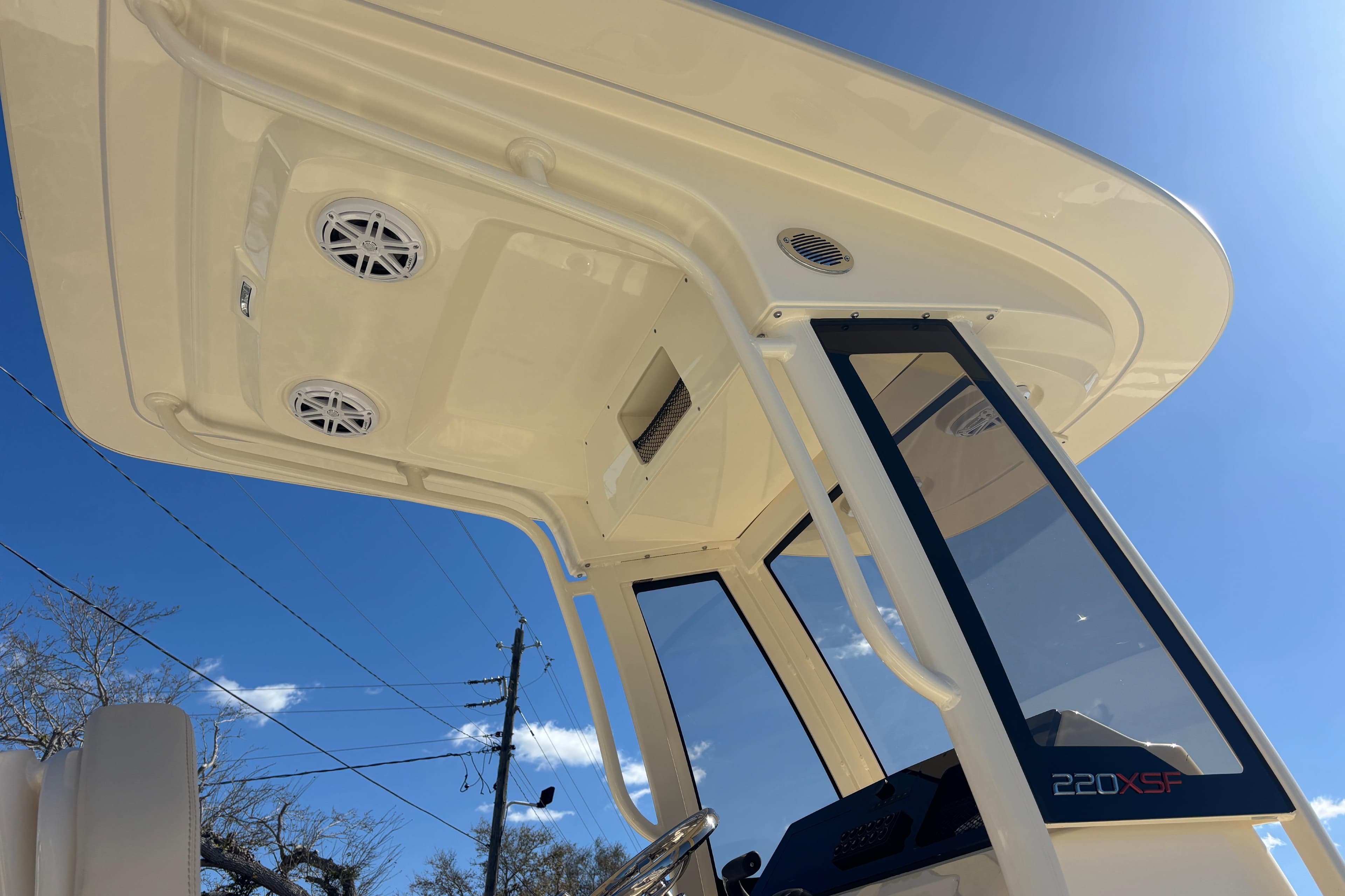 2026 Scout 220 XSF boat canopy and console under clear blue sky.