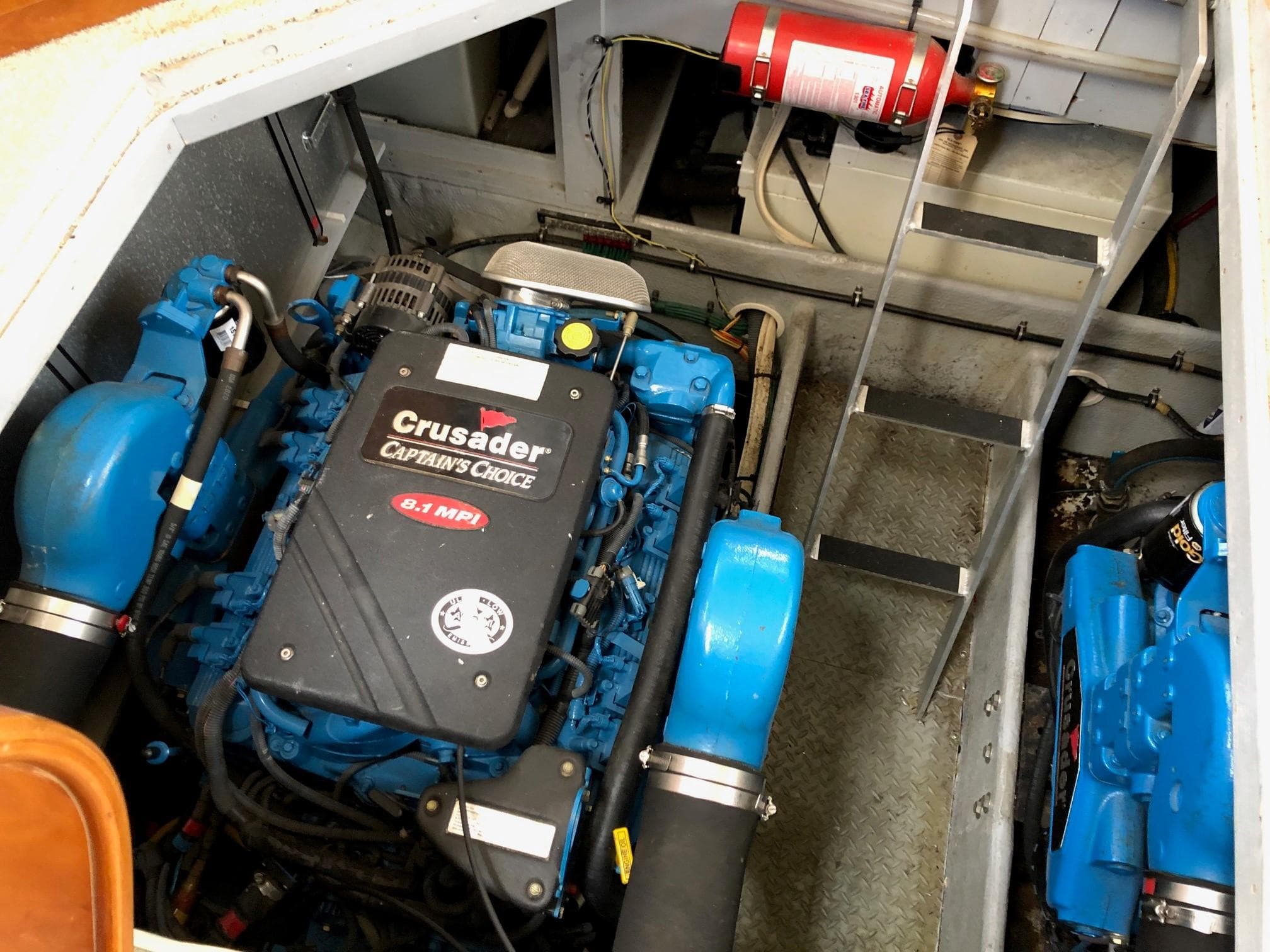 Engine room of 2003 Silverton 35 Motor Yacht with Crusader engines and fire extinguisher.