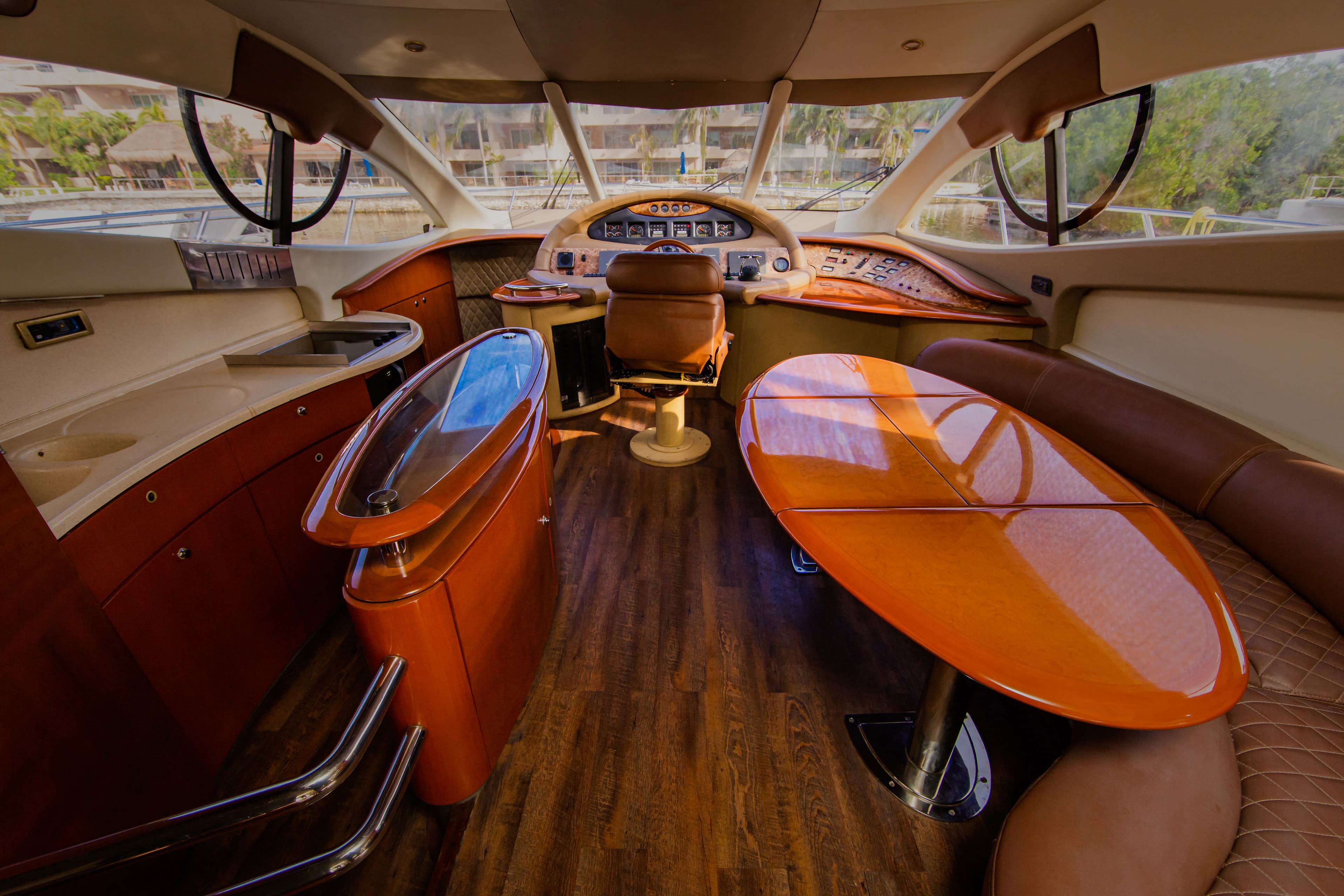 Interior of a 2004 Azimut 55E yacht with luxurious wooden table.