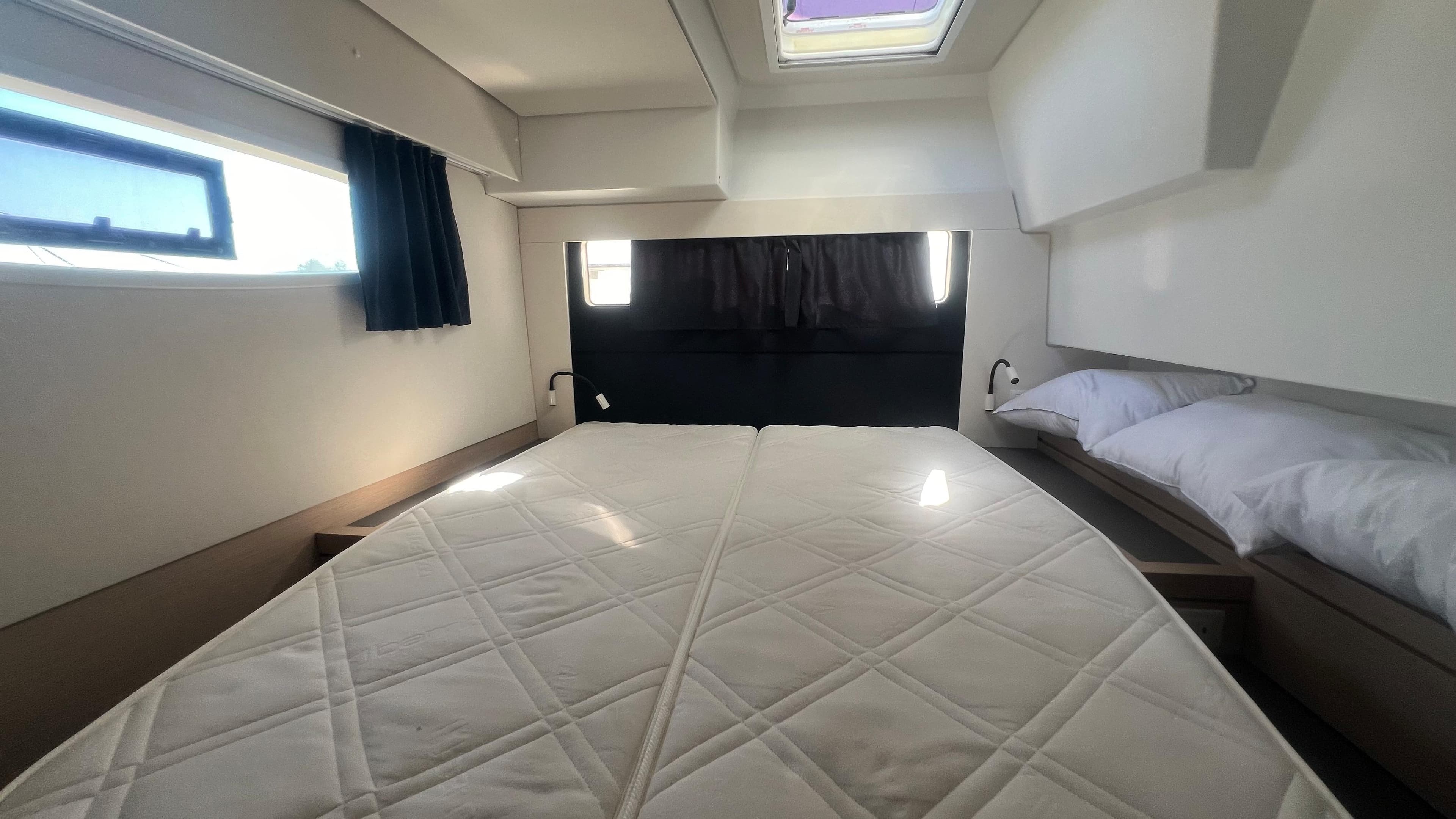 Luxurious cabin interior of 2018 Fountaine Pajot Saona 47 catamaran with skylight and modern design.