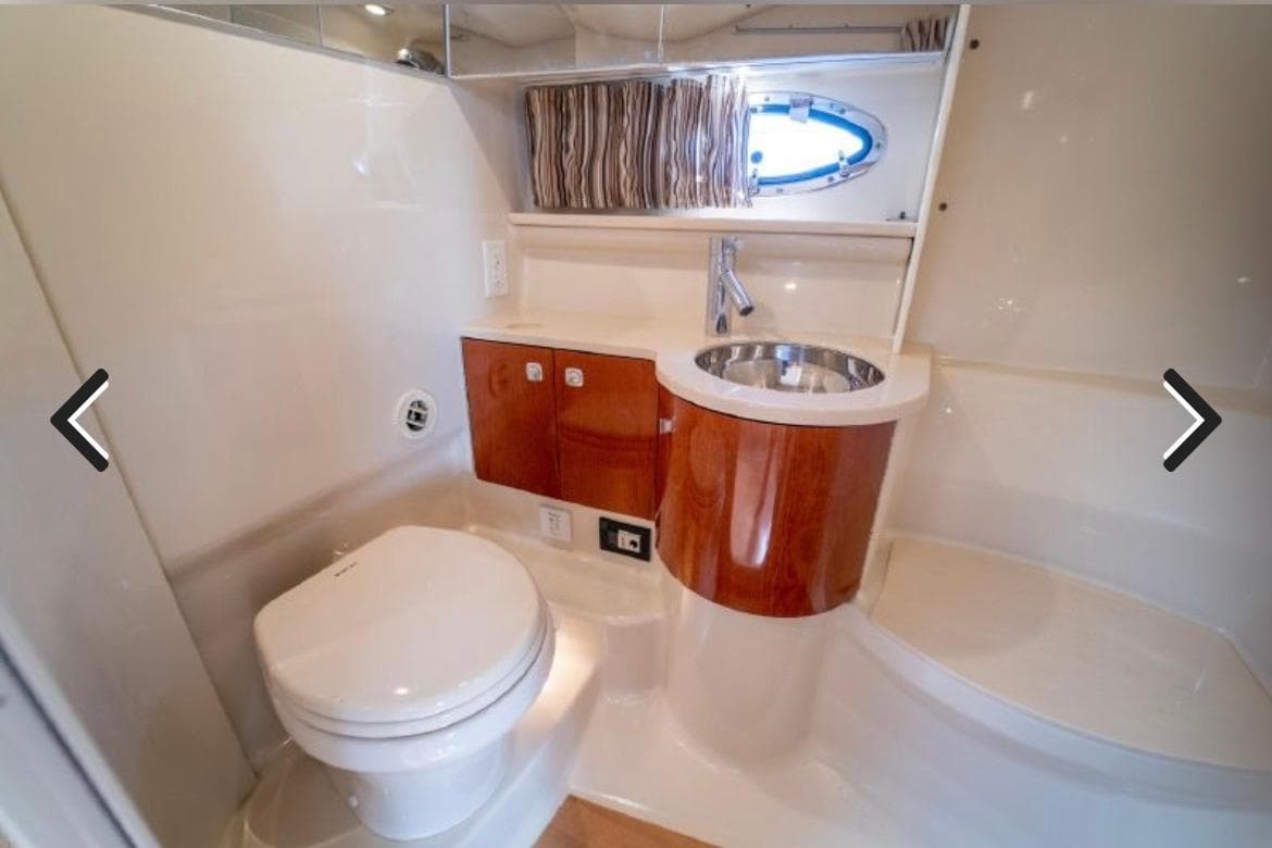 Luxurious bathroom in 2011 Formula 400 Super Sport yacht with modern fixtures and wood accents.