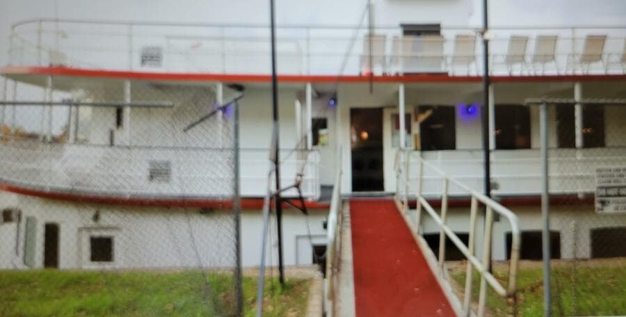 1985 custom dinner excursion passenger boat with red carpeted entrance and upper deck seating.
