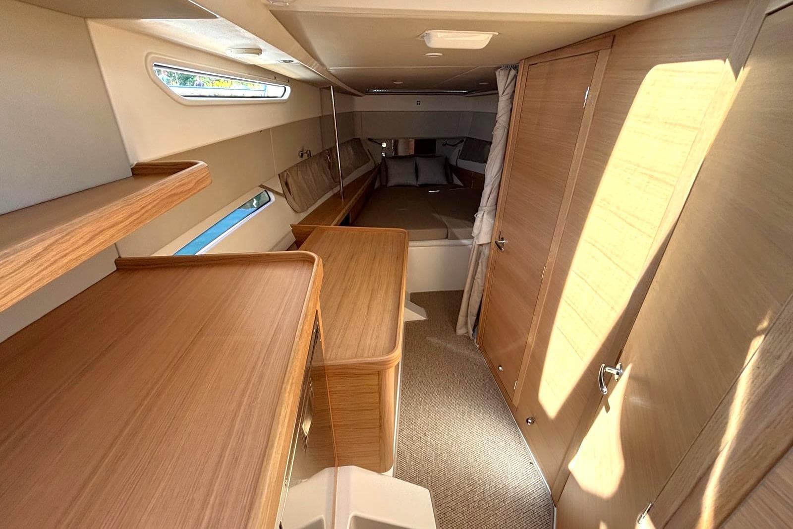 Interior of 2025 Nimbus Weekender 11, featuring modern wood finishes and cozy sleeping area.