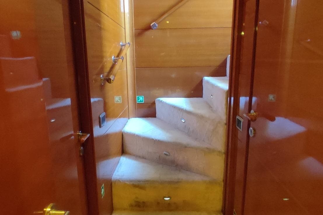 Interior staircase of 2009 Aganlar Custom Built Gulet 34M yacht with wooden finish.