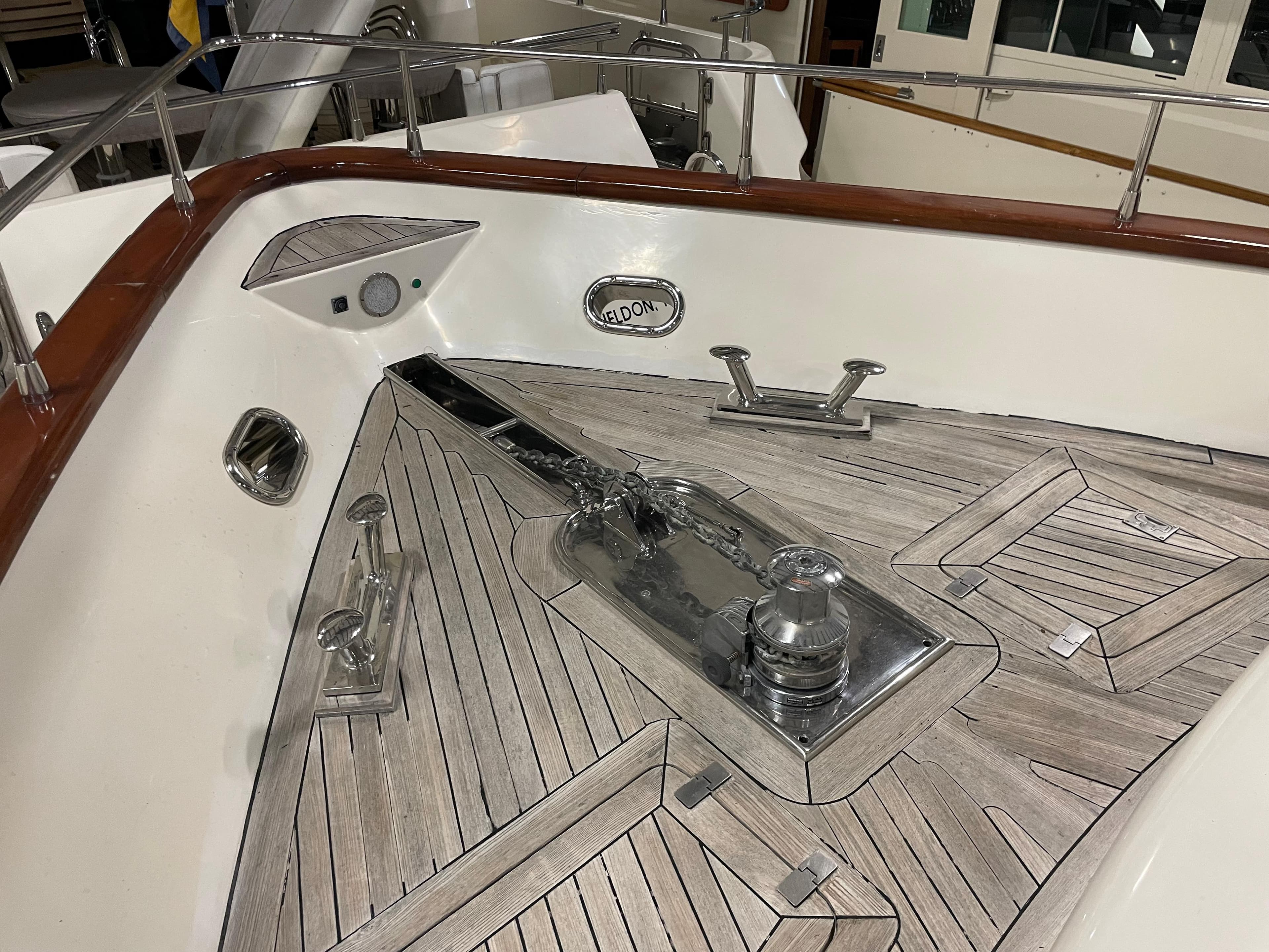 Deck of 2004 Azimut 74 yacht with polished wood and metal fittings.