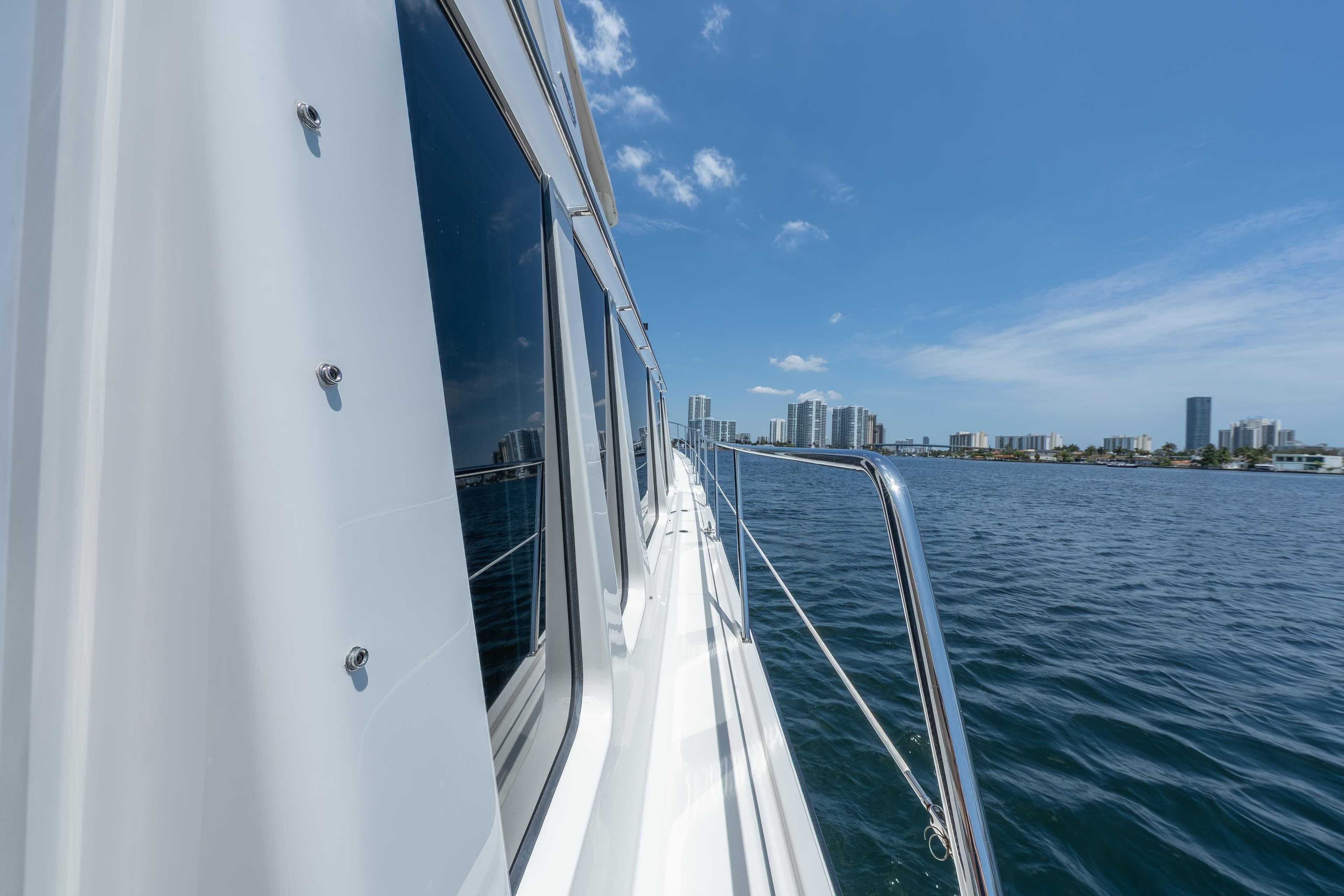 2007 Pacific Mariner Pilothouse yacht cruising near city skyline on a sunny day.