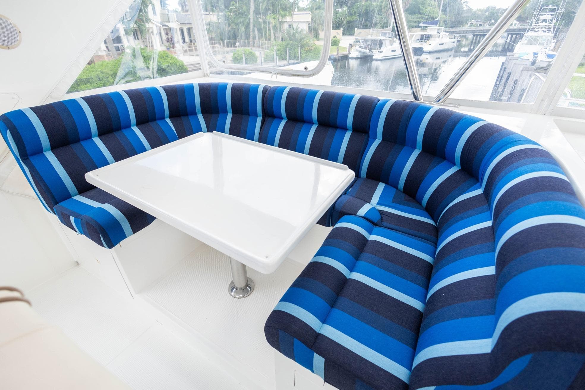 Luxurious blue-striped seating area on 2005 Ocean Alexander yacht.