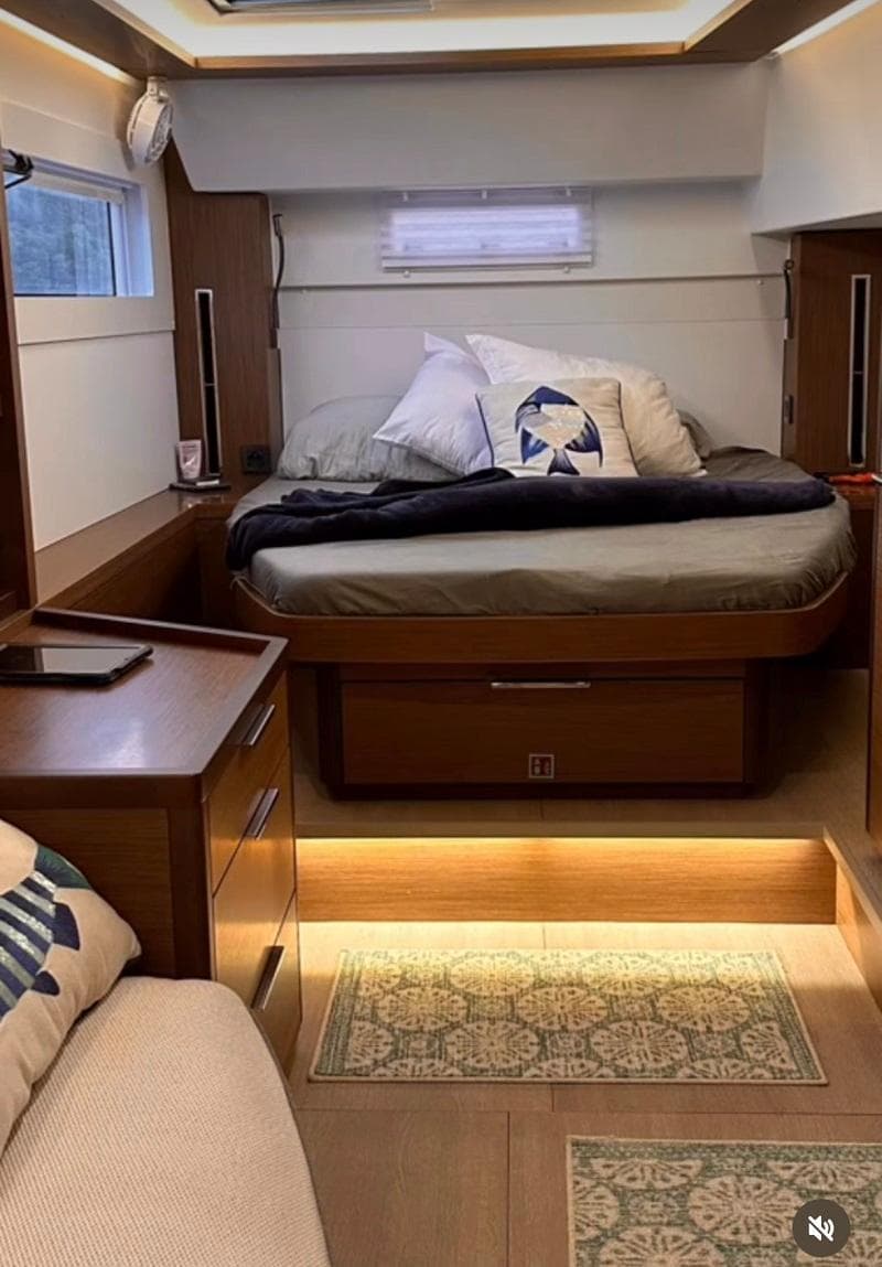 Interior of 2022 Lagoon 46 yacht with cozy bedroom and modern furnishings.
