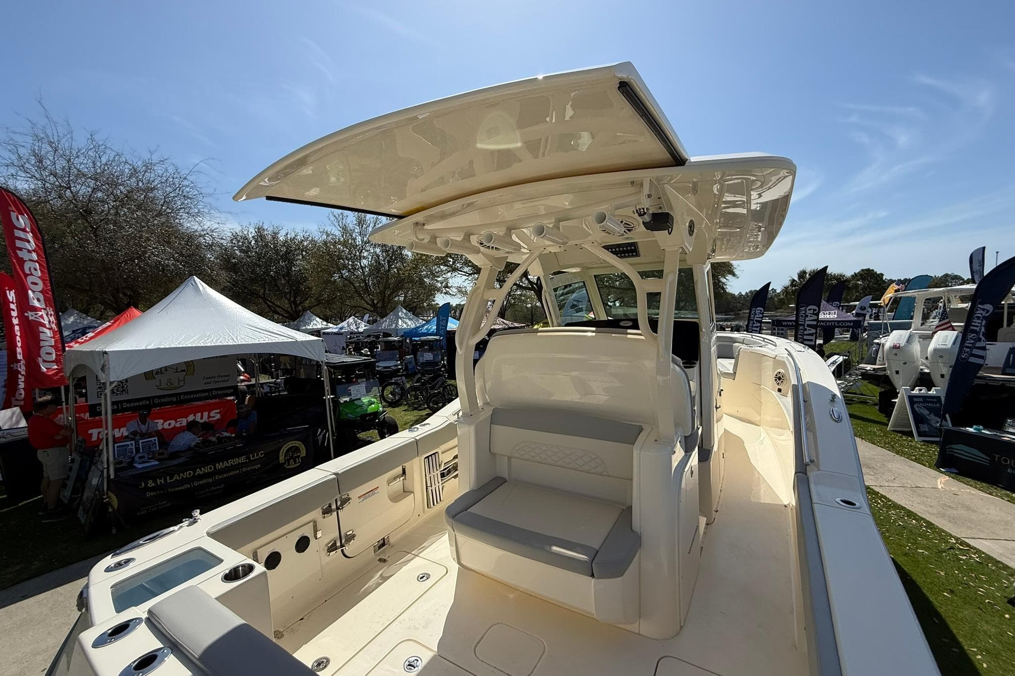 2026 Scout 330 LXF boat at outdoor exhibition, showcasing sleek design and modern features.