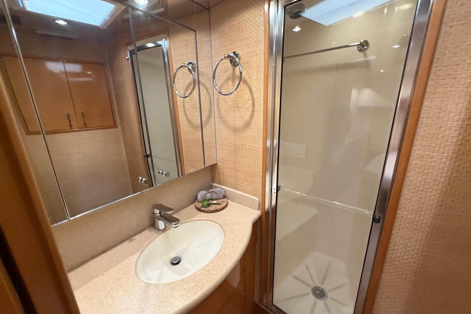 Luxurious bathroom in 2003 Hatteras 54 Convertible yacht with shower and vanity.