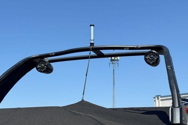 2023 Chaparral 267 SSX boat tower with speakers against clear blue sky.