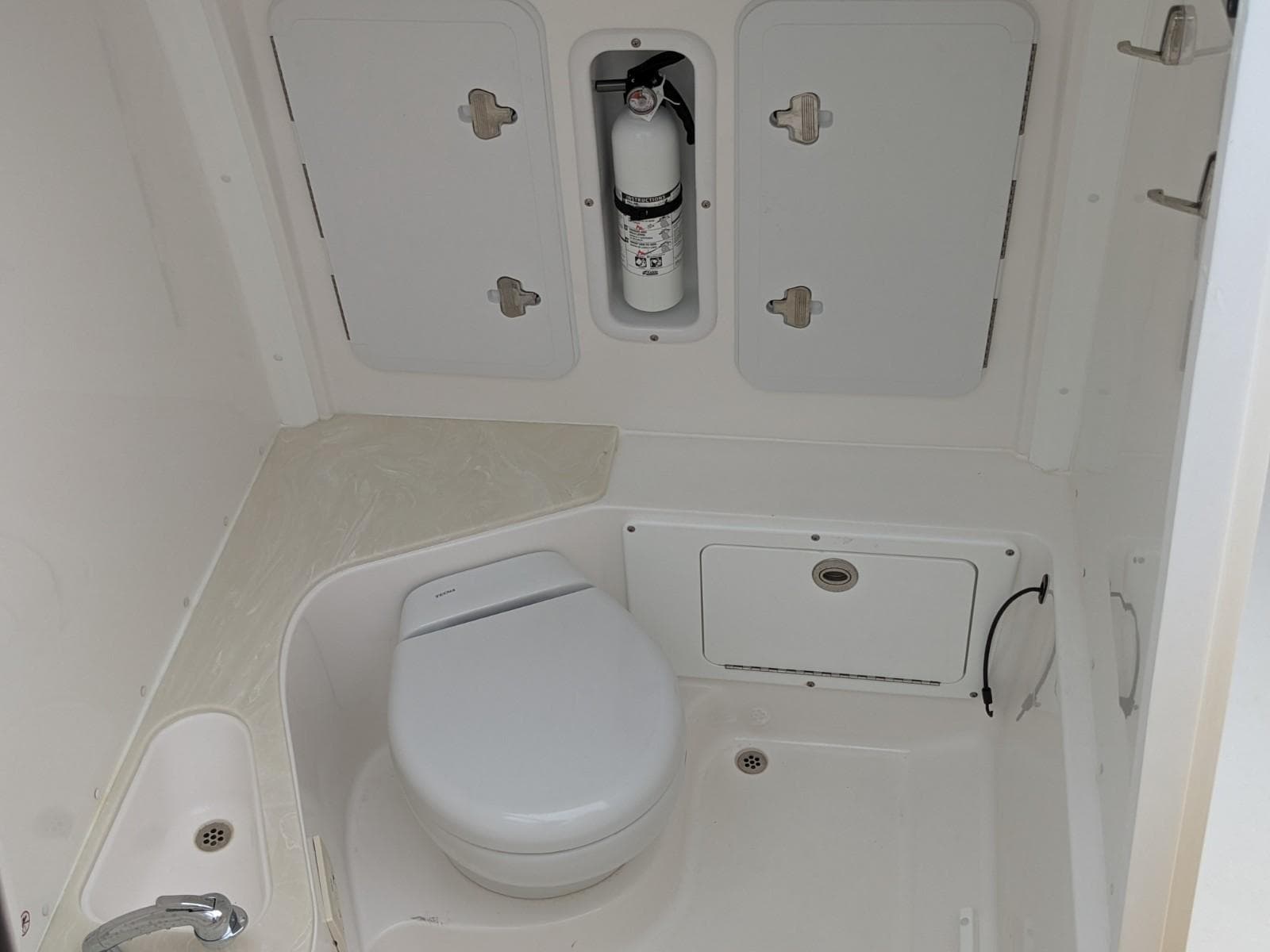 2021 Edgewater 262 CC boat interior with toilet and storage compartments.
