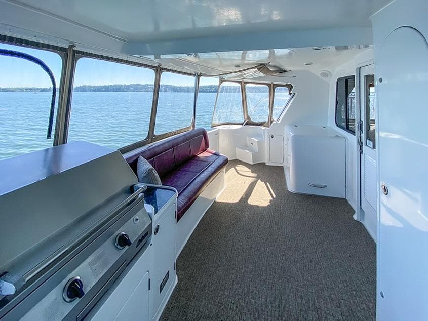 Spacious interior of 2001 Malcolm Tennant Pachoud Pilothouse Powercat with panoramic windows.