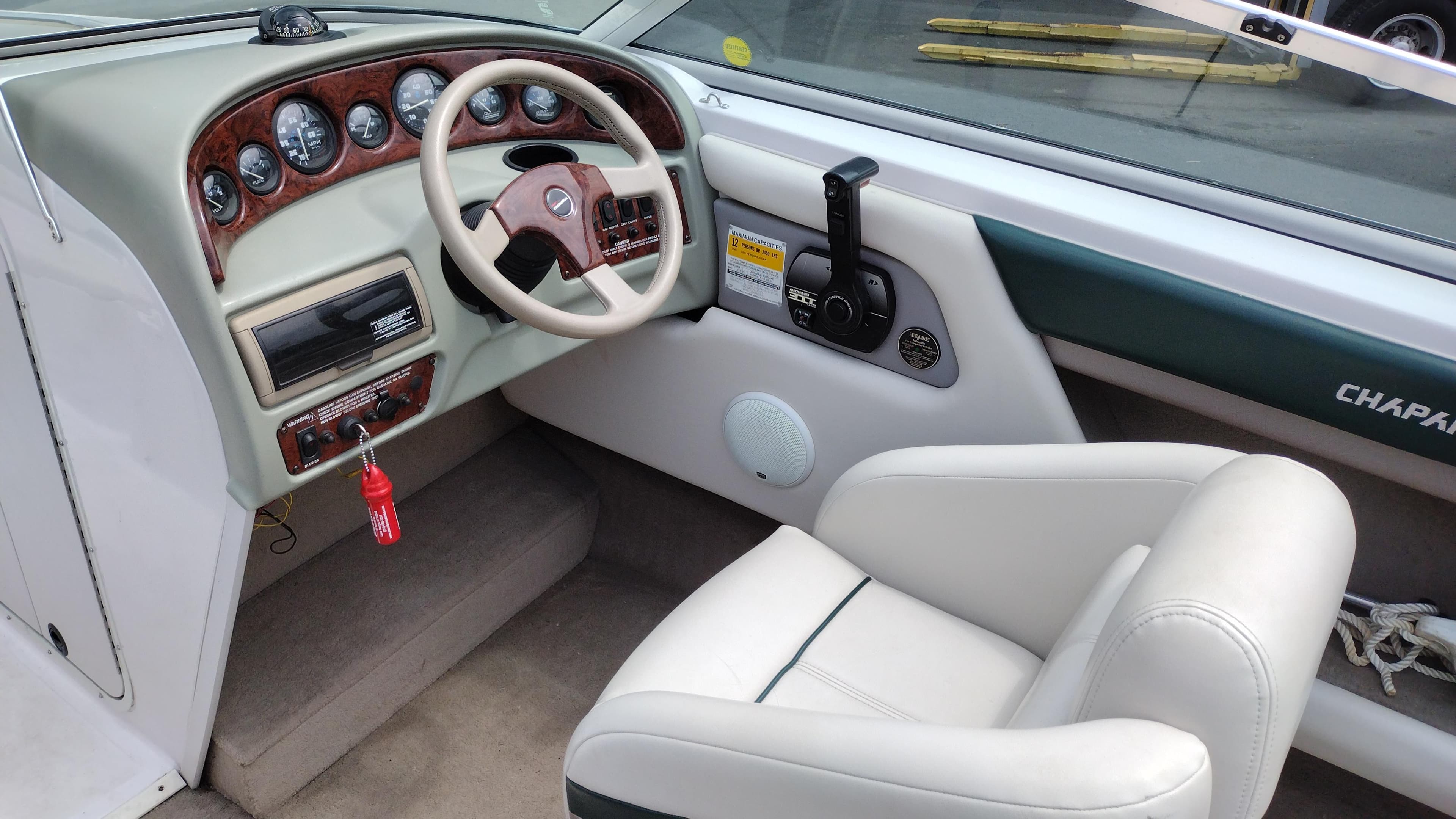 1996 Chaparral 2330 SS boat cockpit with steering wheel and control panel.