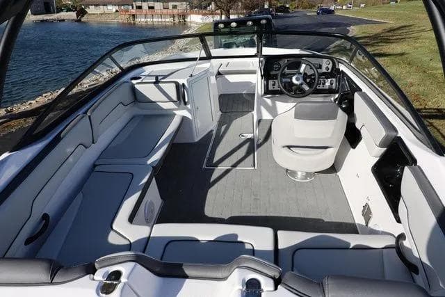 2026 Yamaha Boats AR190 interior with sleek seating and modern dashboard by the water.