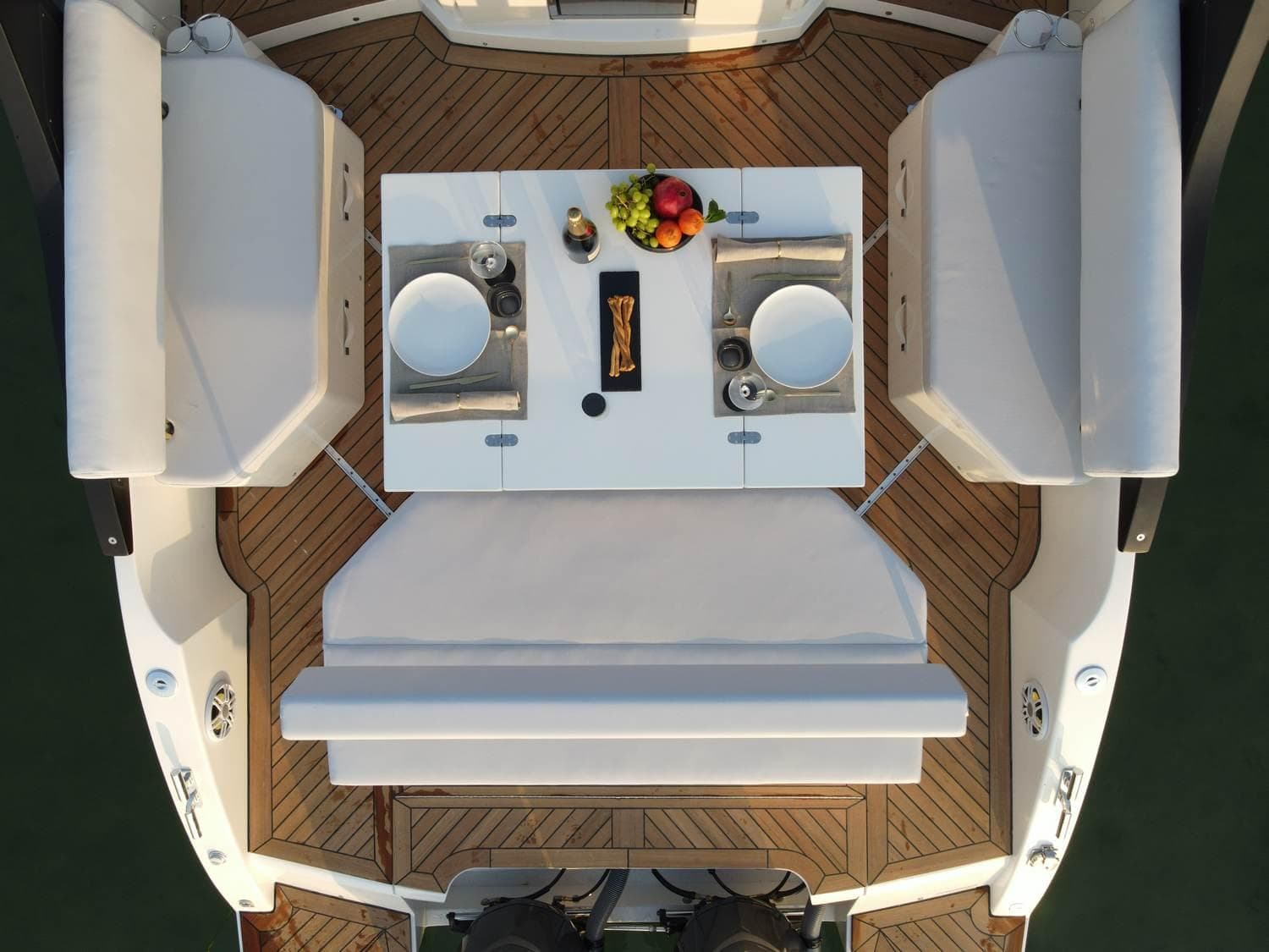 Luxurious 2023 FIM 340 REGINA yacht deck with elegant dining setup and fruit centerpiece.