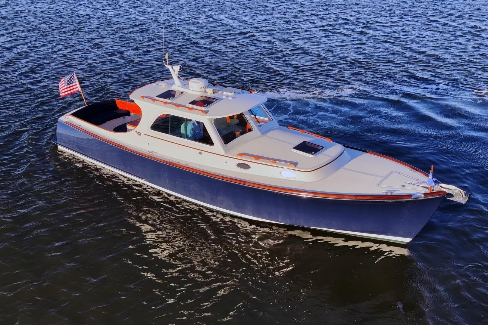 2004 Hinckley Picnic Boat 36 EP cruising on open water, displaying elegant design and craftsmanship.