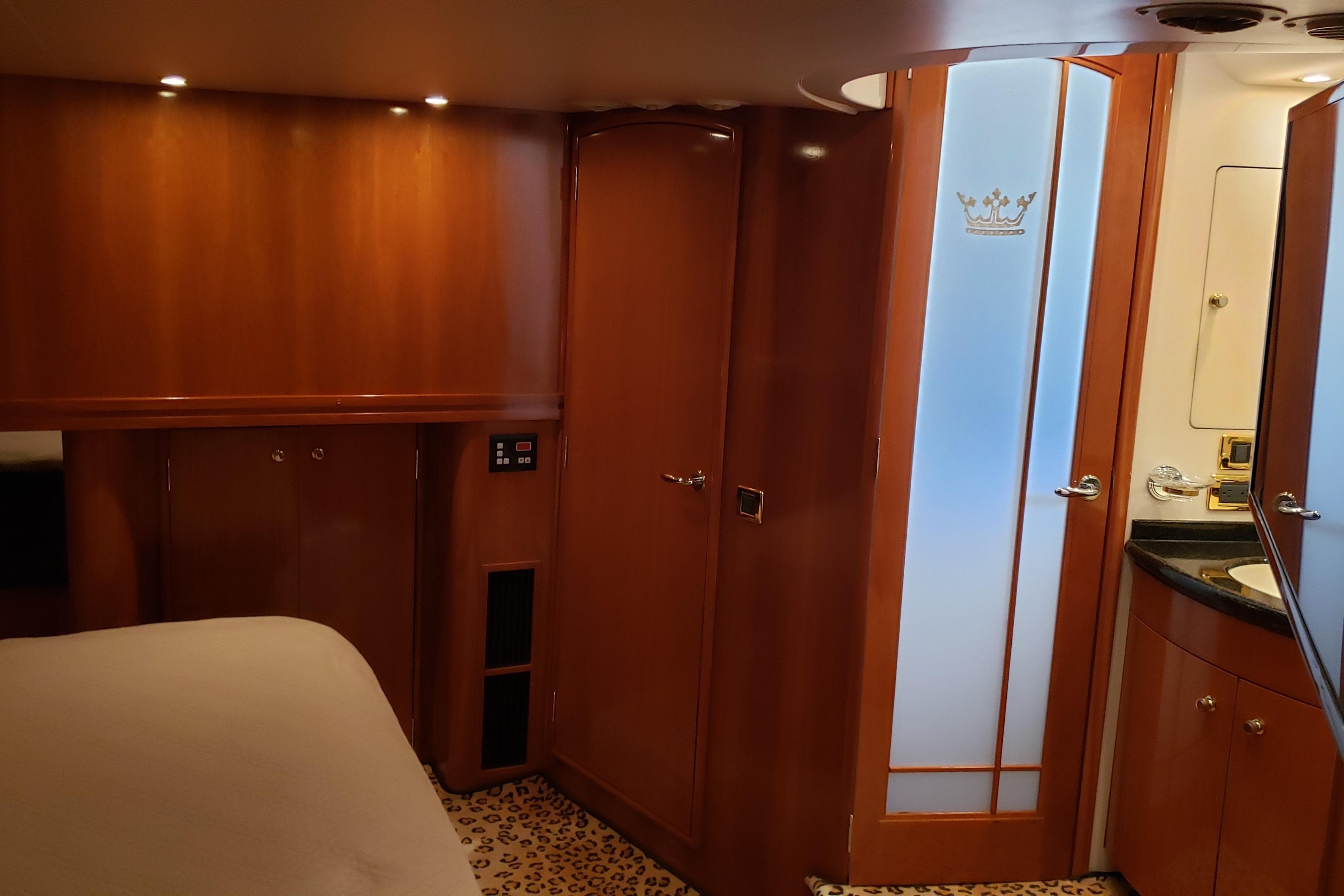 Luxurious interior of 2002 Carver 570 Voyager Pilothouse with wood paneling and frosted glass door.