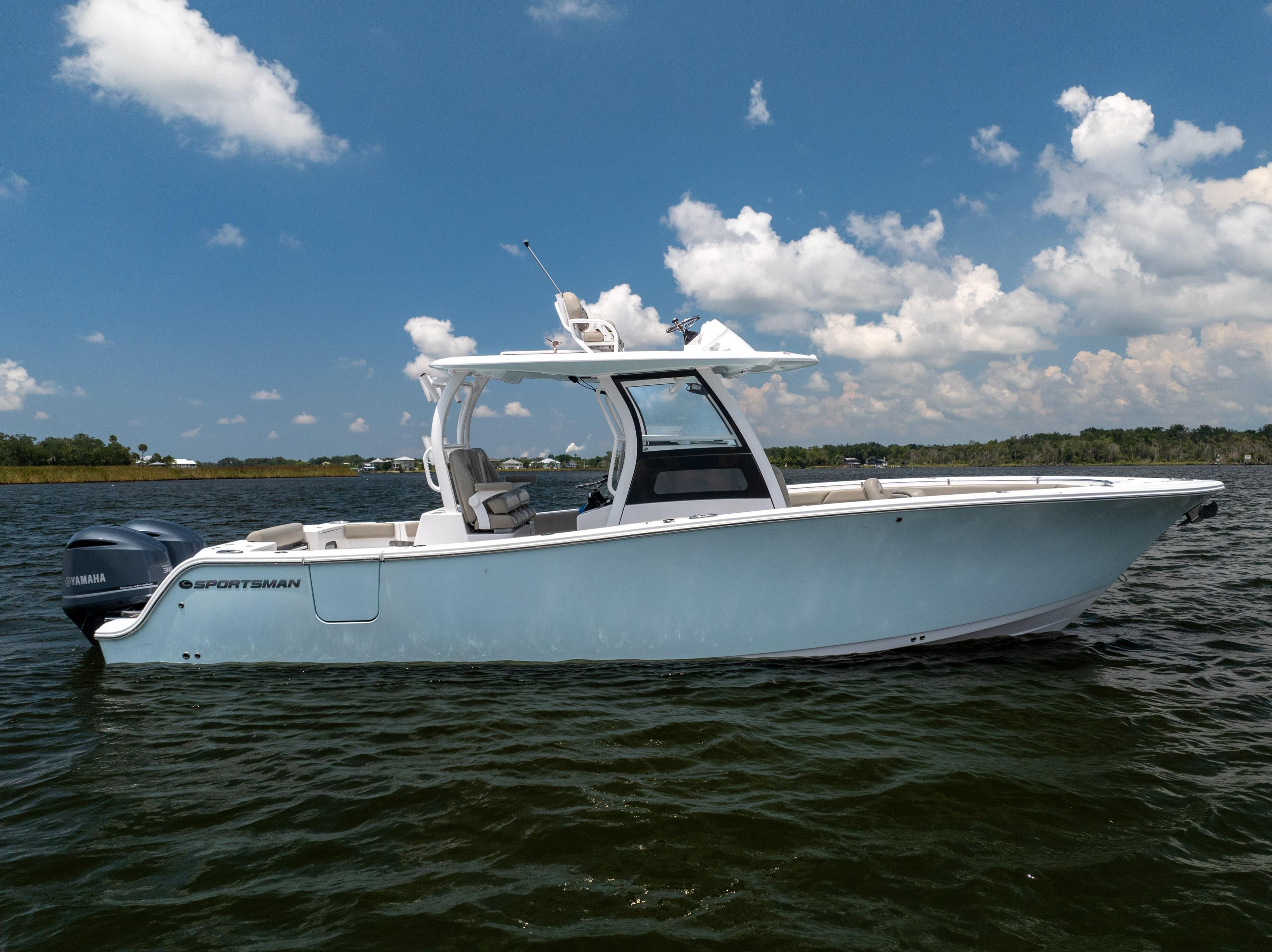 2021 Sportsman Open 302 Center Console boat on calm water under blue sky.