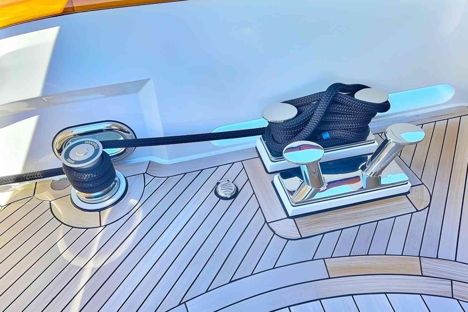 Deck of 2003 Trinity Yachts Motoryacht with polished cleats and rope.