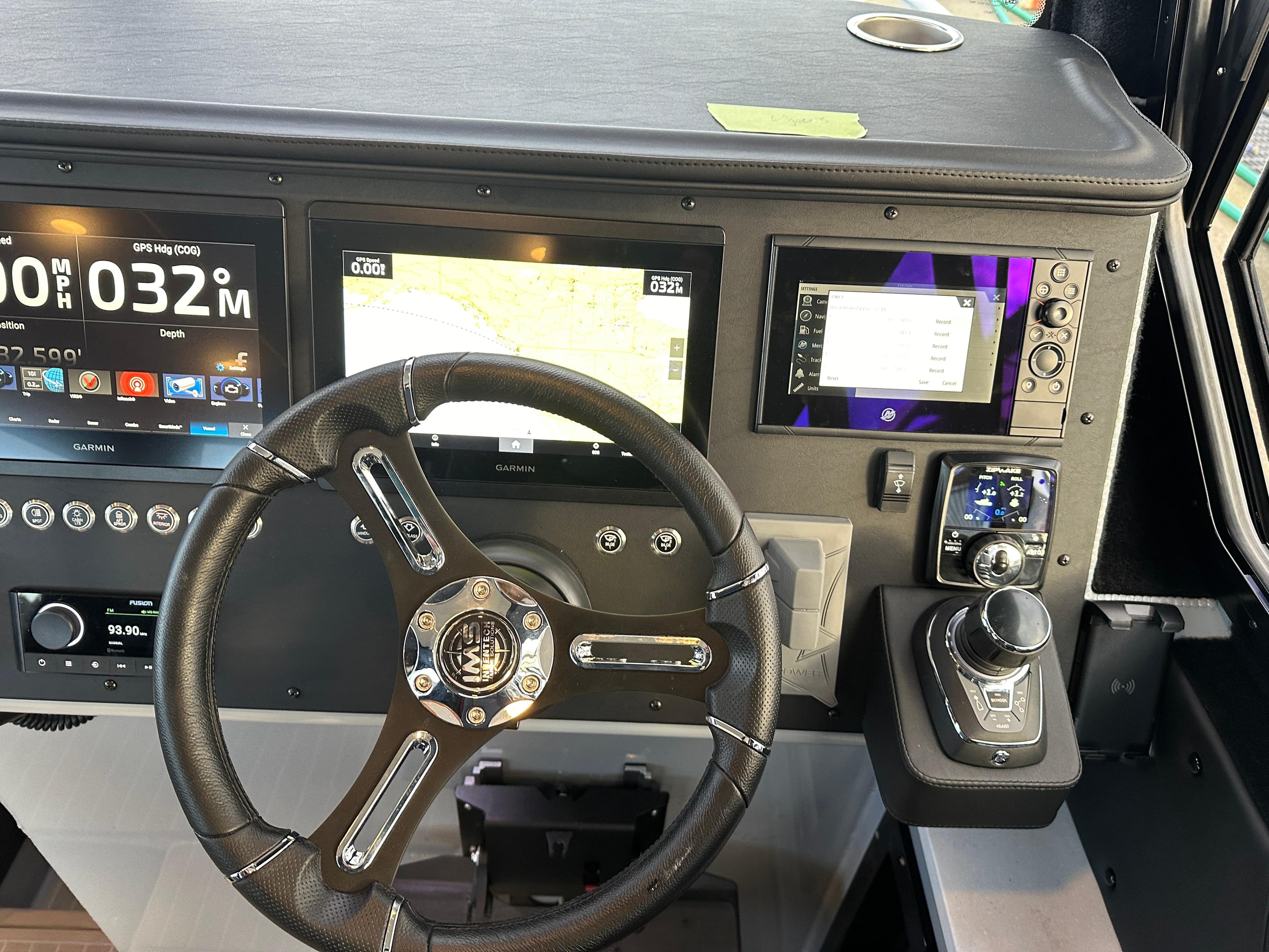 2023 Life Proof 35 Full Cabin dashboard with steering wheel and navigation screens.