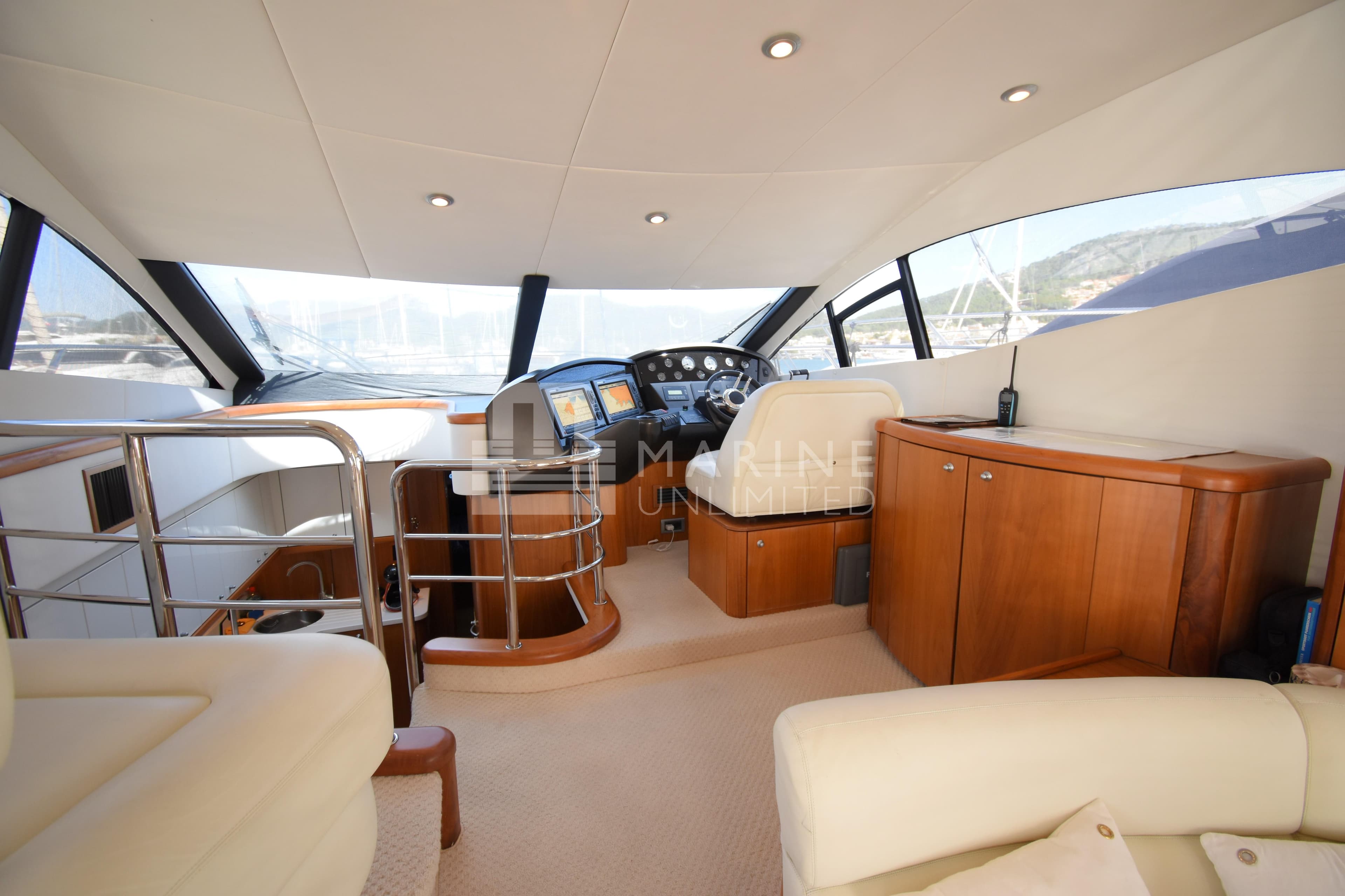 Interior of 2010 Sunseeker Manhattan 52 yacht, featuring helm and luxurious seating.