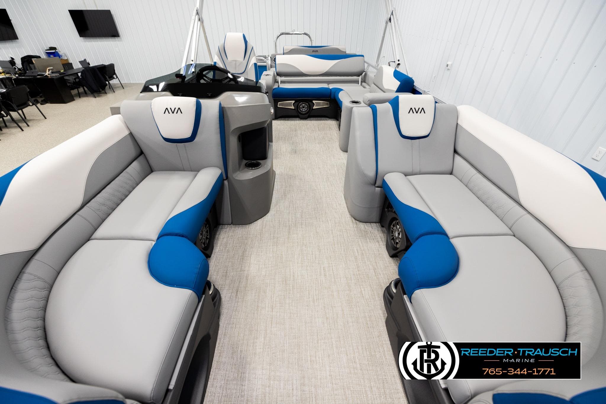 2026 Avalon LSZ Vrl pontoon boat interior with blue and gray seating, displayed indoors.